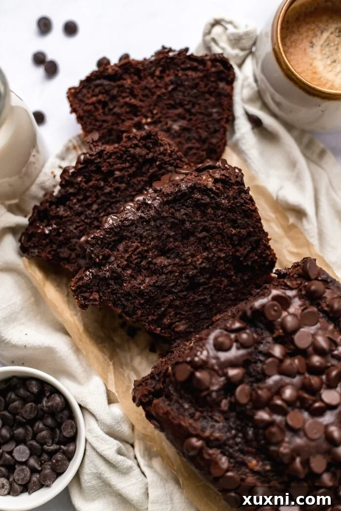 Beautifully cut slices of vegan chocolate banana bread presented on a platter, showcasing the rich, dark color and inviting texture of the bread.