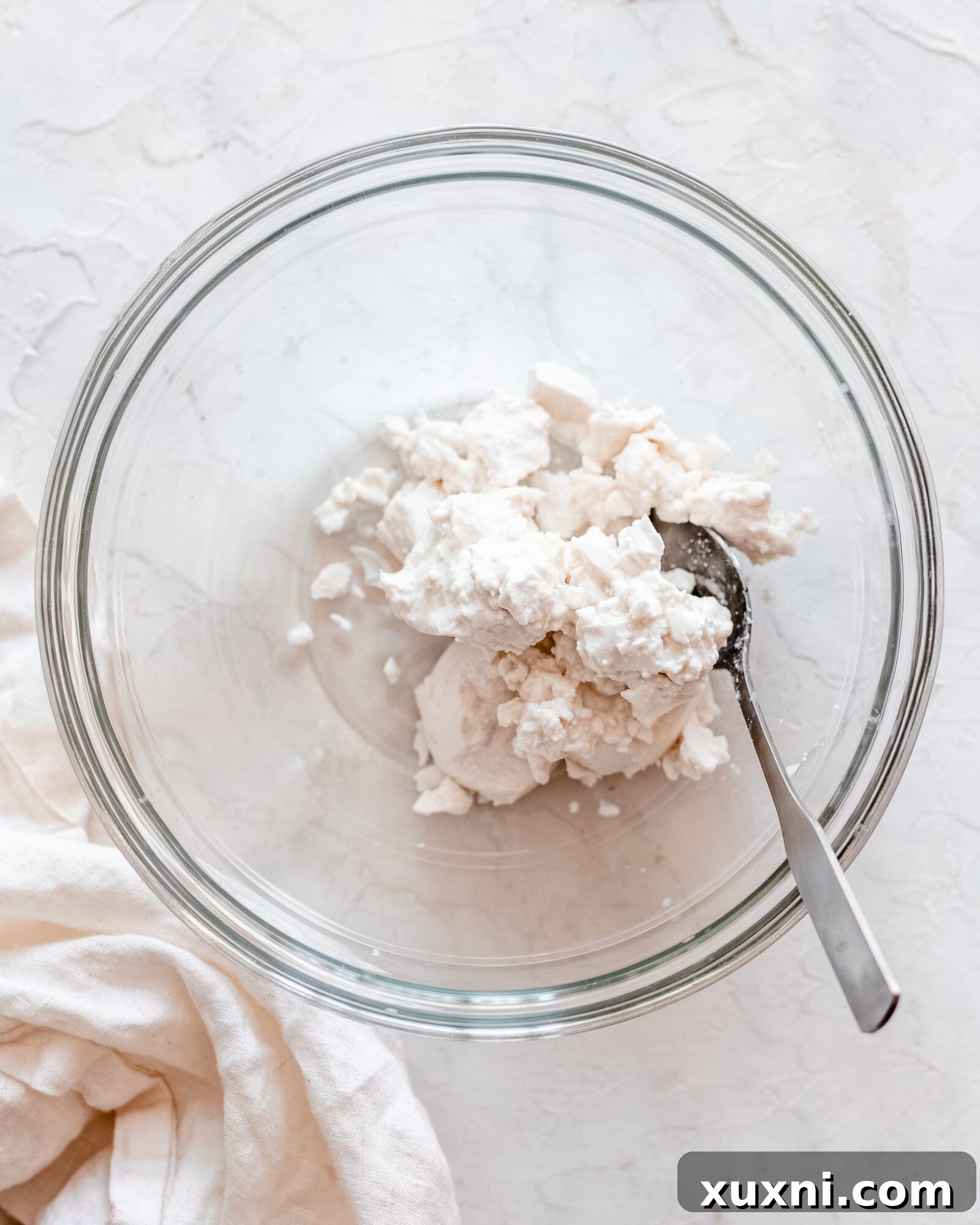 Solidified coconut cream in a chilled mixing bowl