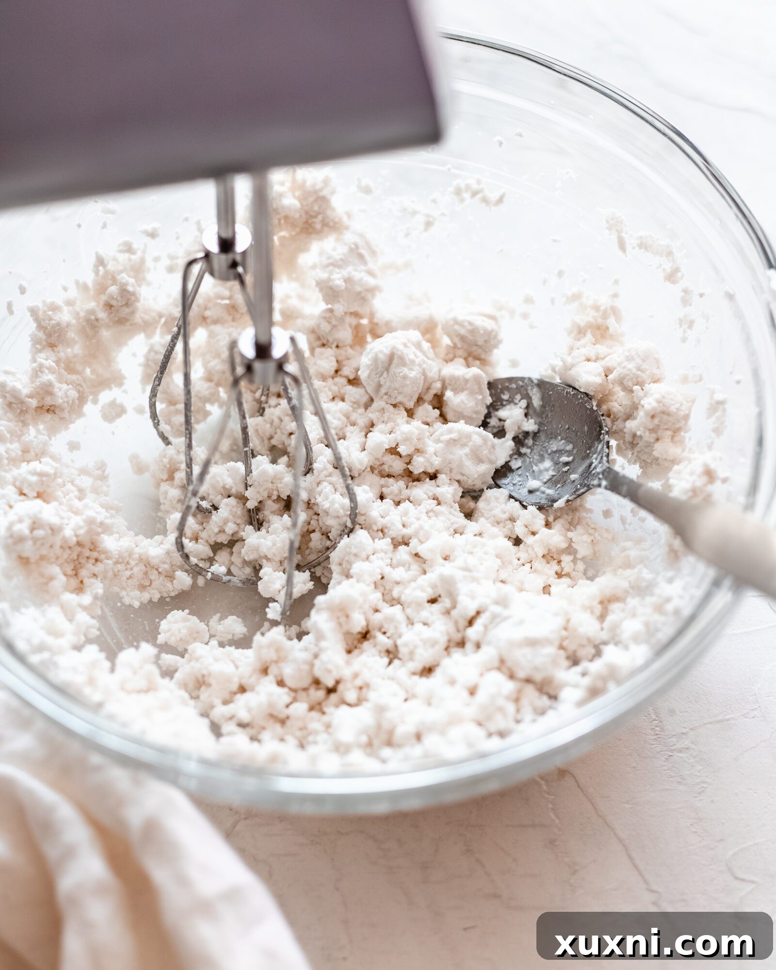 Coconut cream being whipped with a hand mixer