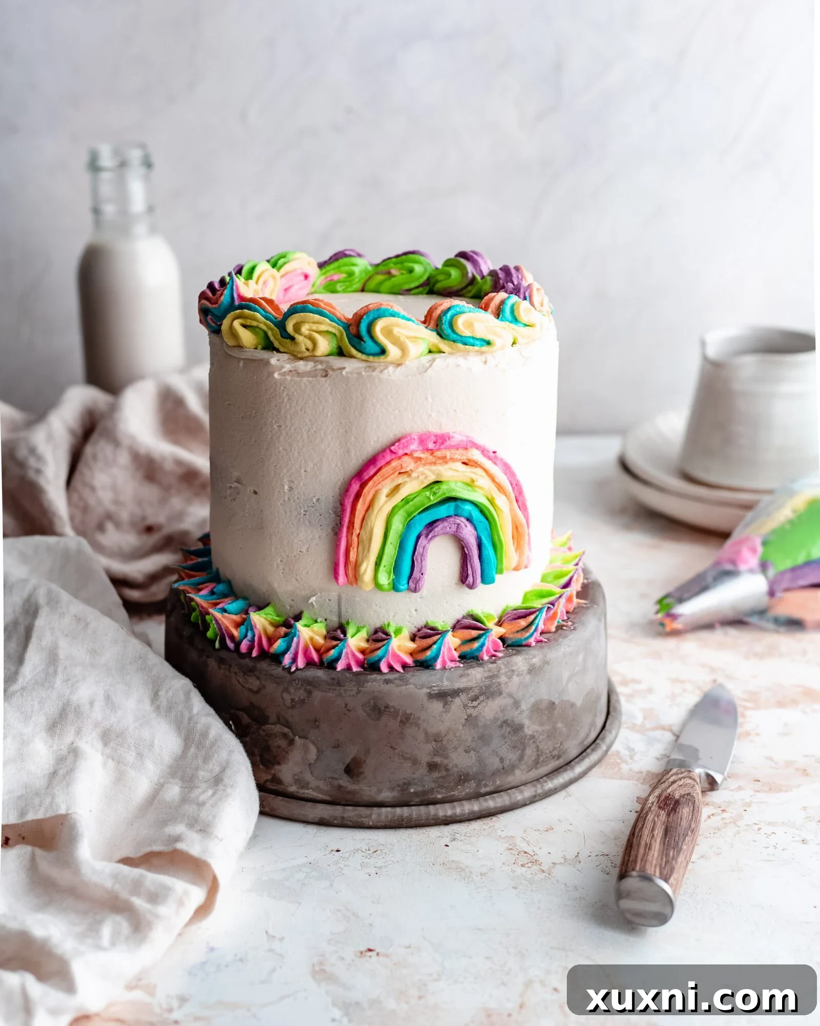A beautifully decorated rainbow swirl cake with vibrant colors