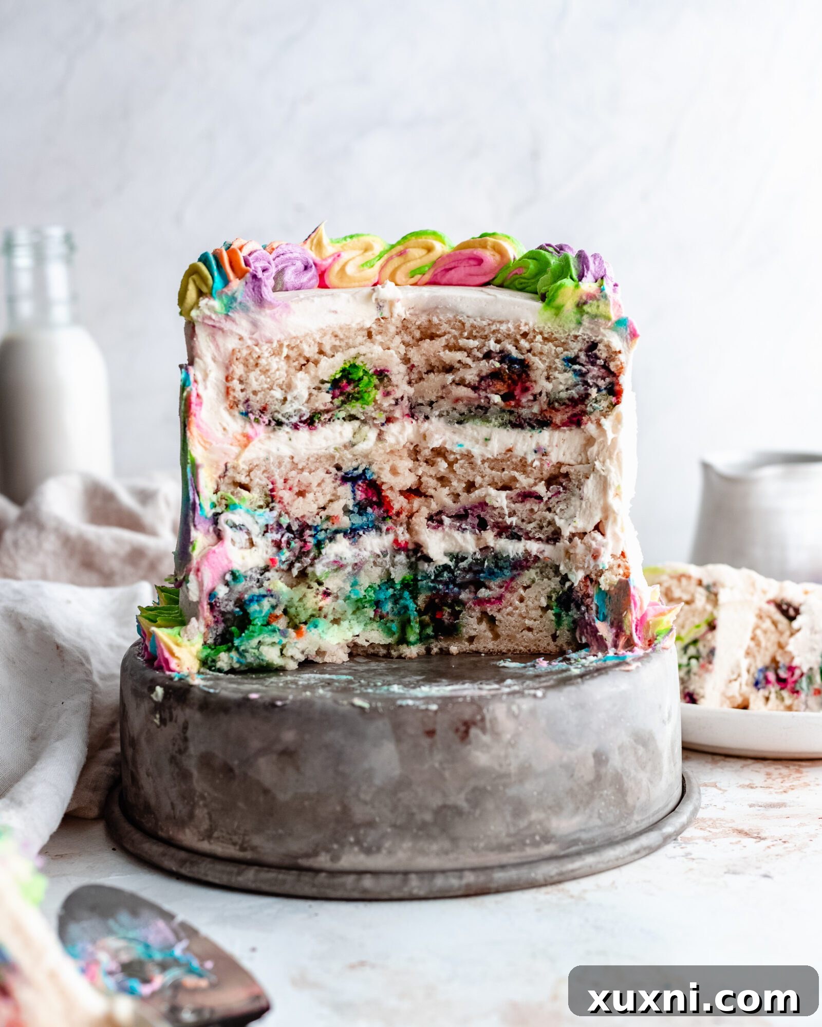 Close up of a whole vegan rainbow cake, beautifully decorated