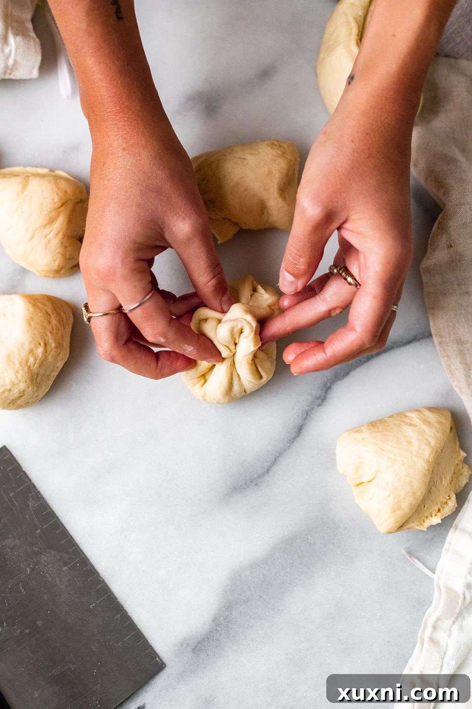 hands shaping vegan dinner rolls