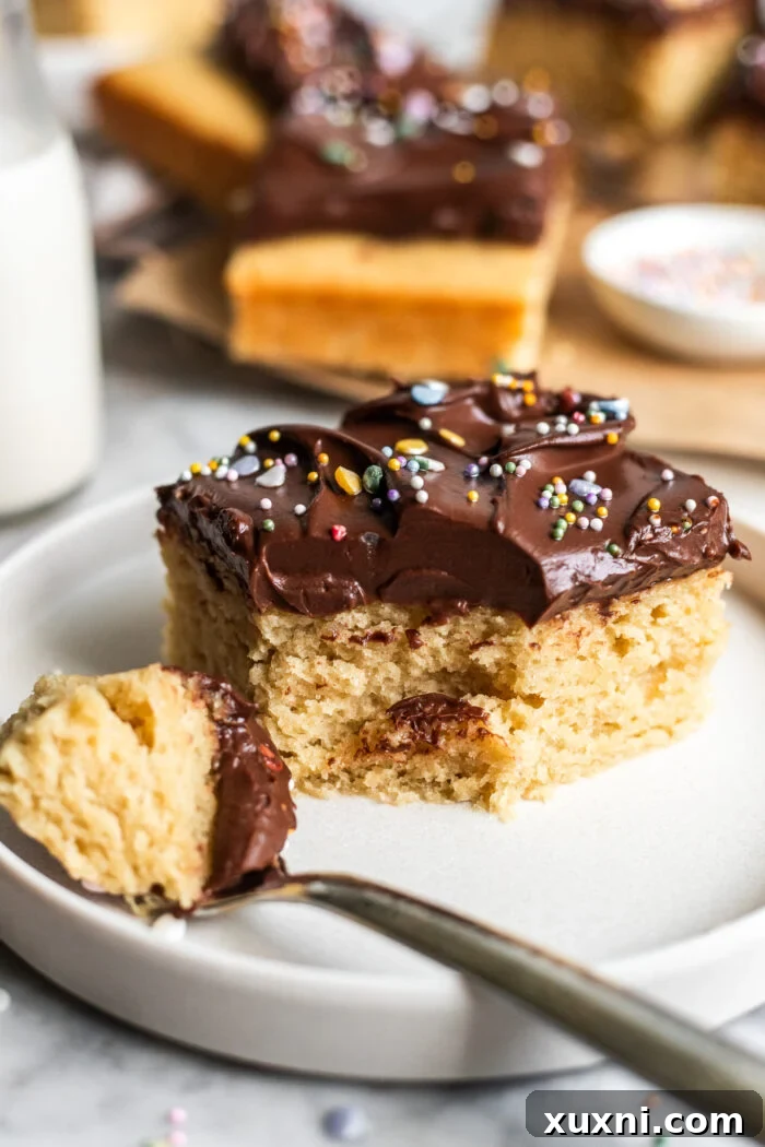 Close-up of a bitten slice of vegan birthday cake with sprinkles