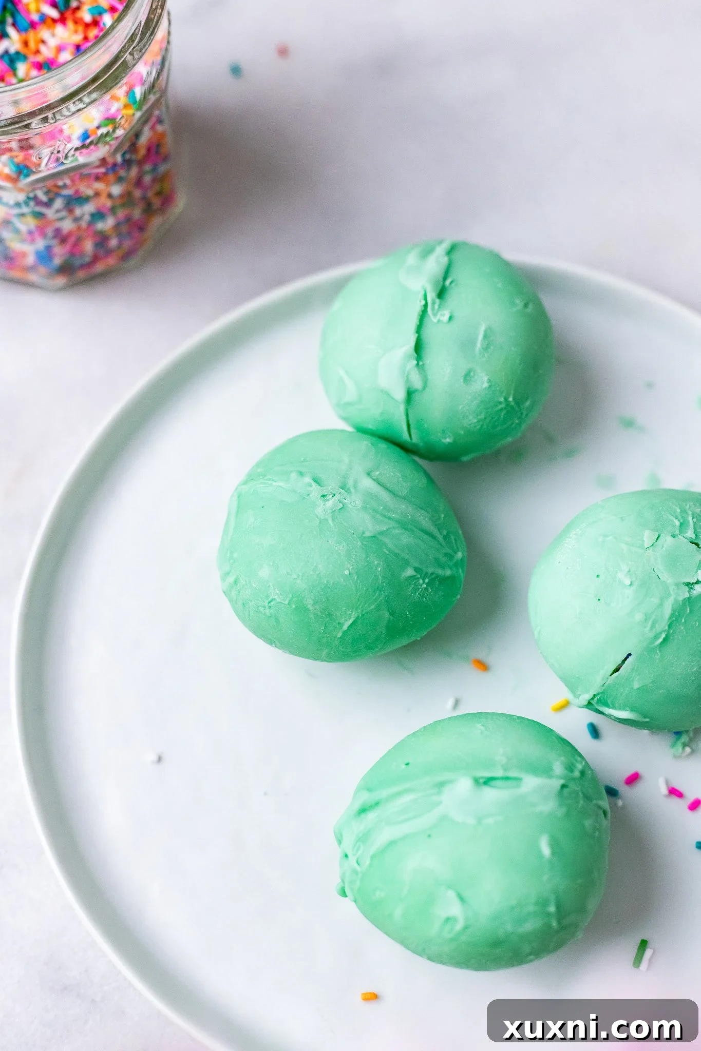 Seamlessly sealed vegan white chocolate eggs, smooth and ready for their speckled decoration.