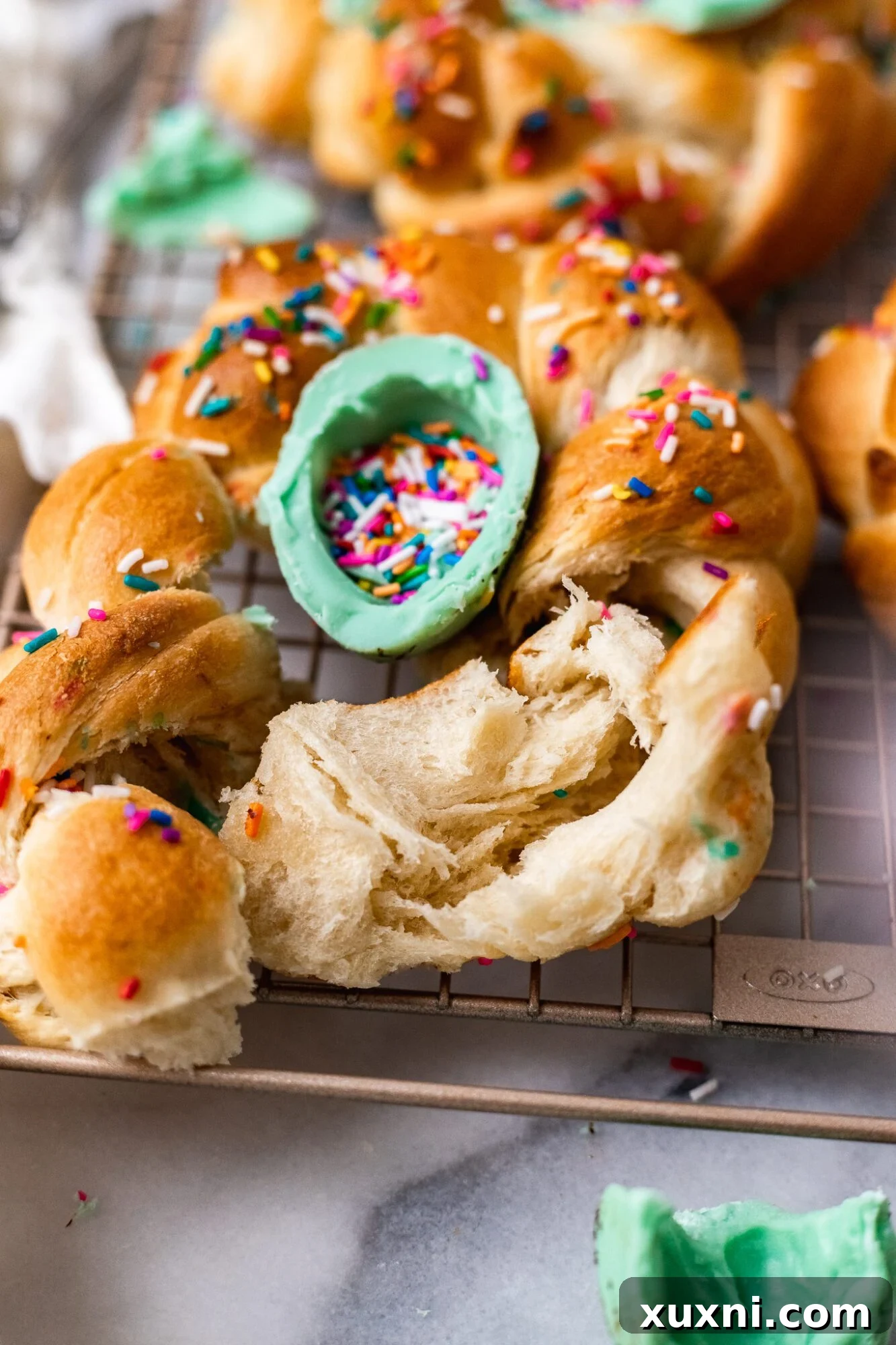 A section of vegan Pane di Pasqua, artfully torn open to reveal its incredibly soft and airy interior, highlighting its perfect texture.