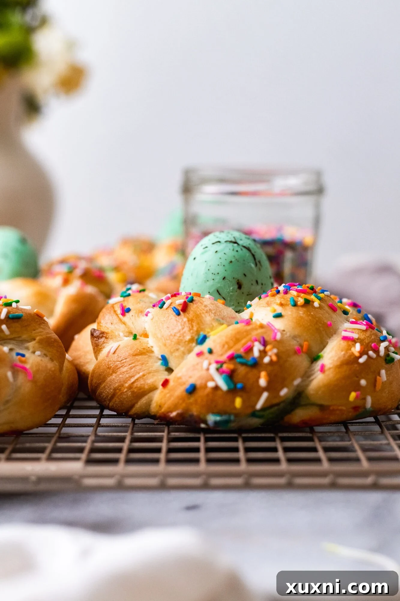 A freshly baked vegan Pane di Pasqua, beautifully braided and golden, cooling on a rack, awaiting its festive vegan egg.
