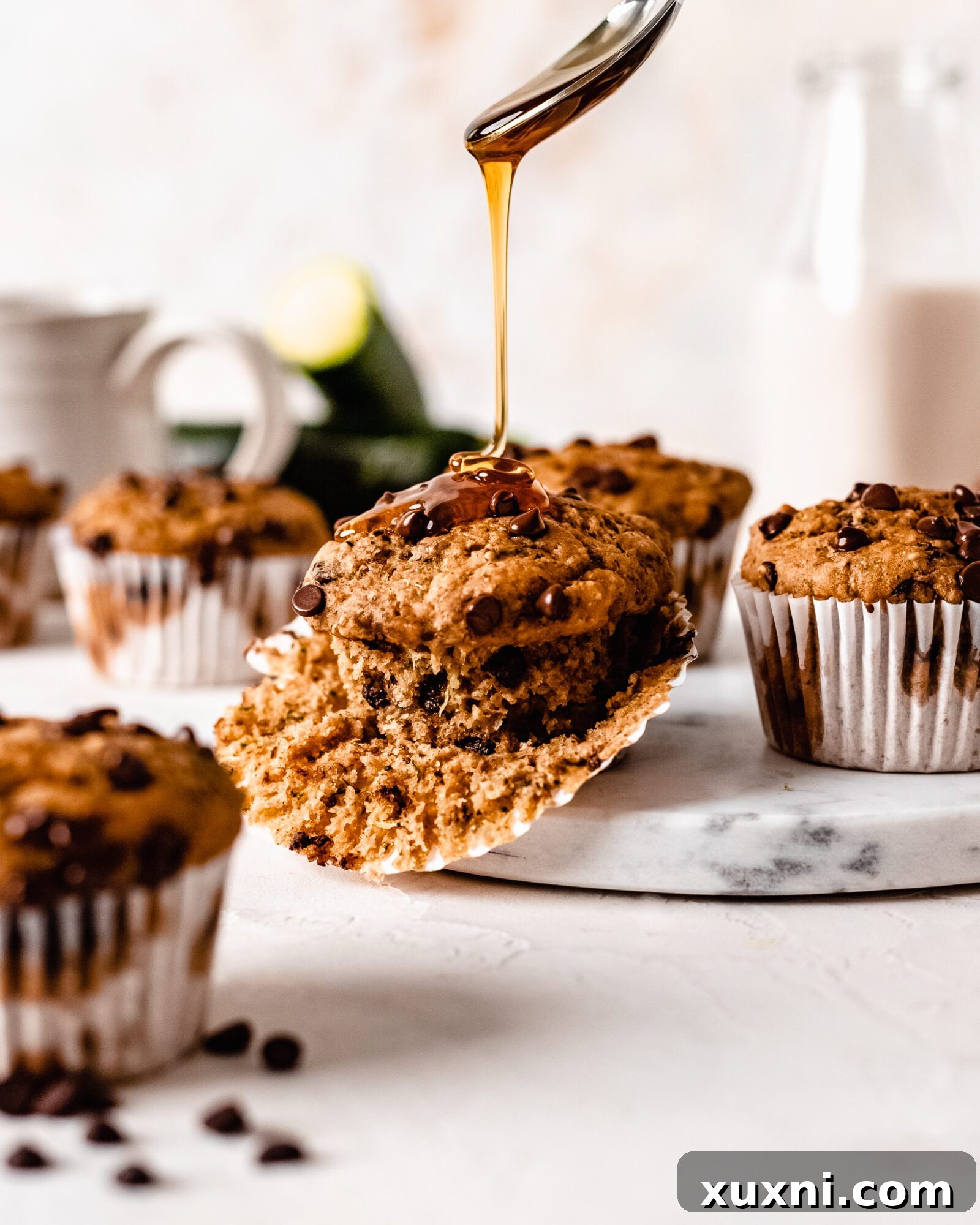 Irresistible vegan zucchini muffins with a delicate drizzle, showcasing their moist interior and sweet appeal.