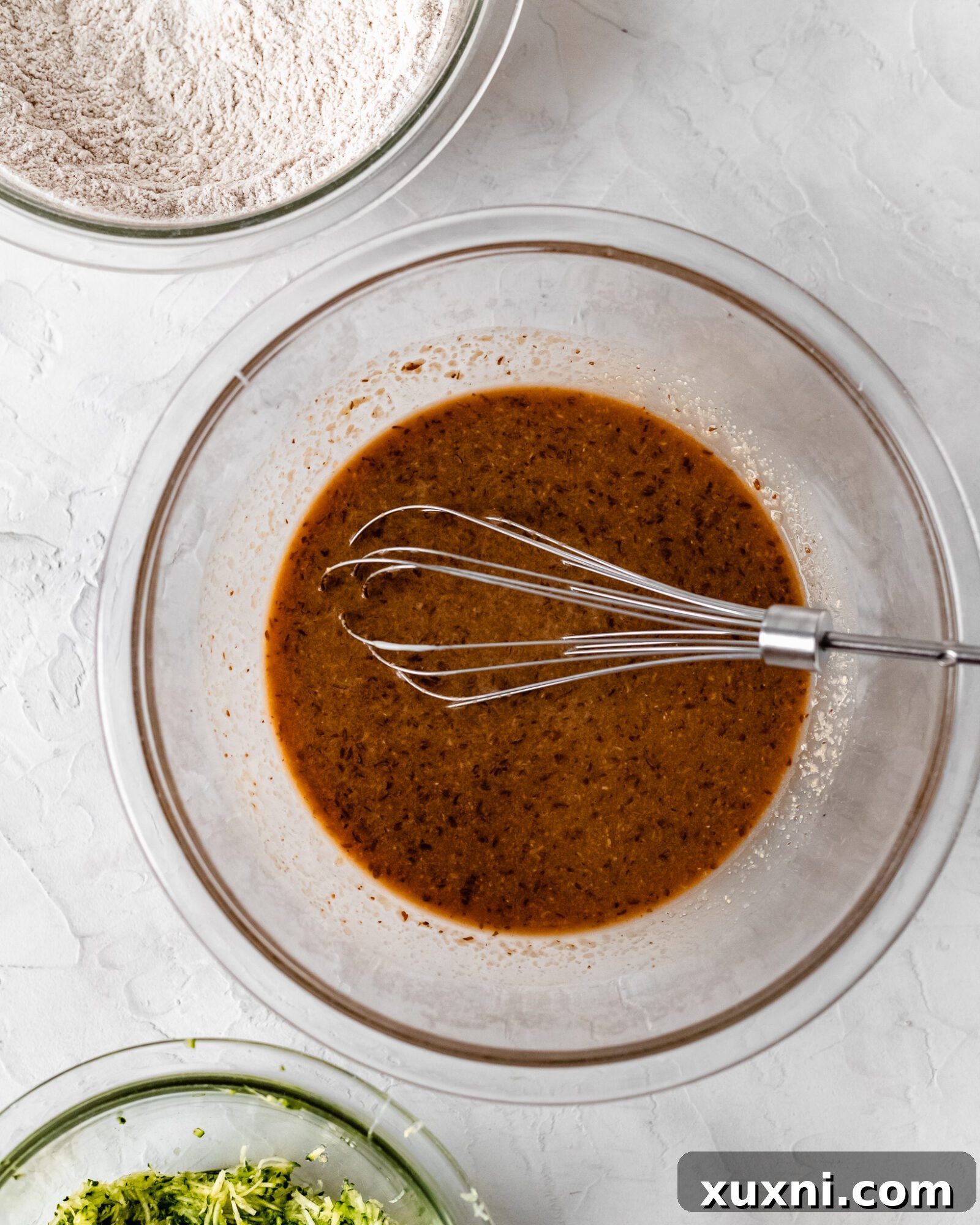 A bowl of freshly grated zucchini, ready to be incorporated into the muffin batter.