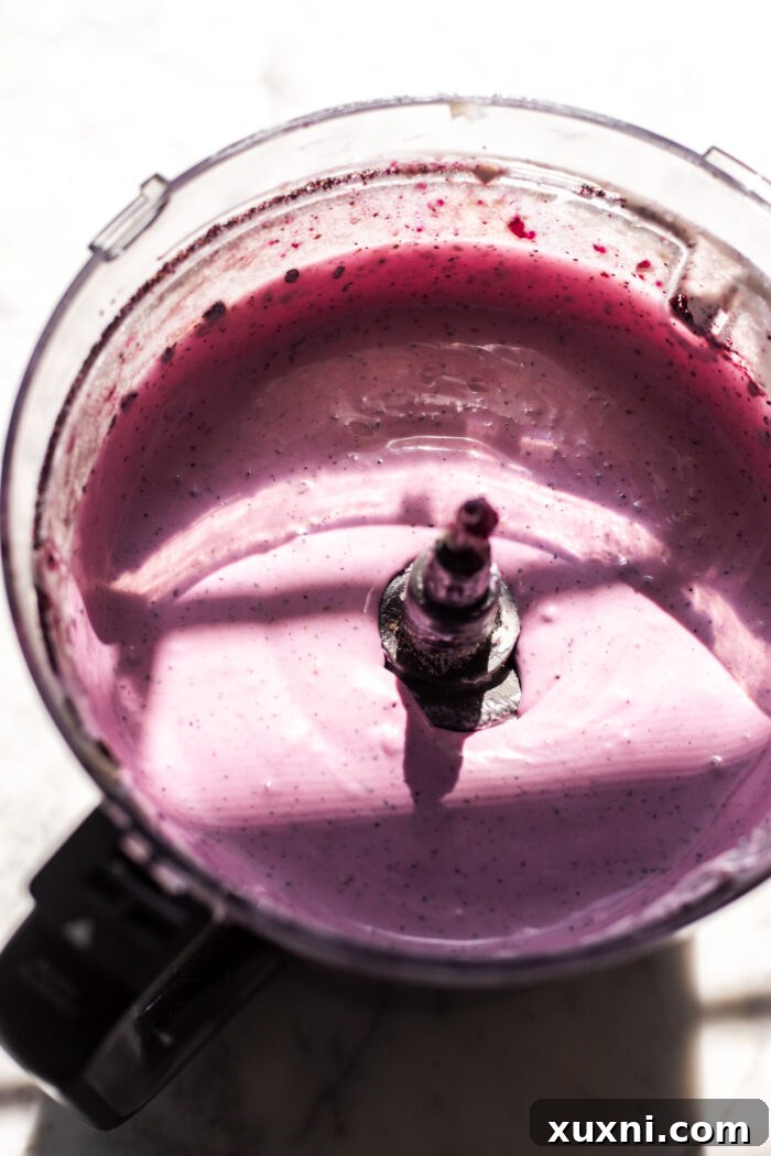 Smooth, vibrant purple blueberry cheesecake filling after blending in a food processor.