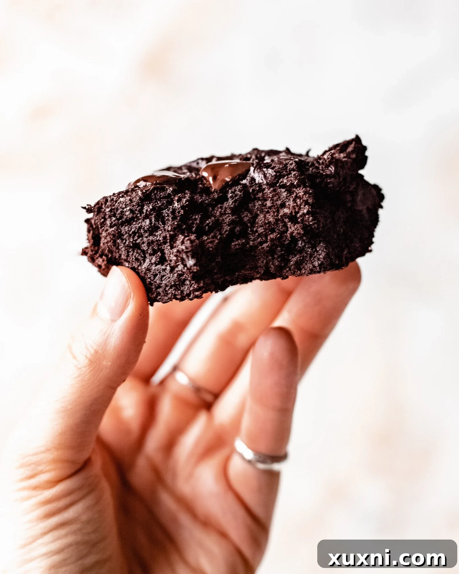 hand holding up zucchini brownie