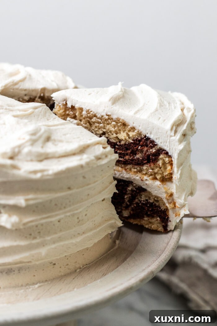 A close-up of a perfectly sliced piece of vegan zebra cake, ready to enjoy.