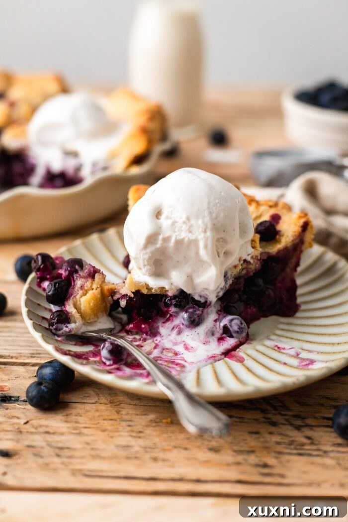 slice of vegan blueberry pie bitten