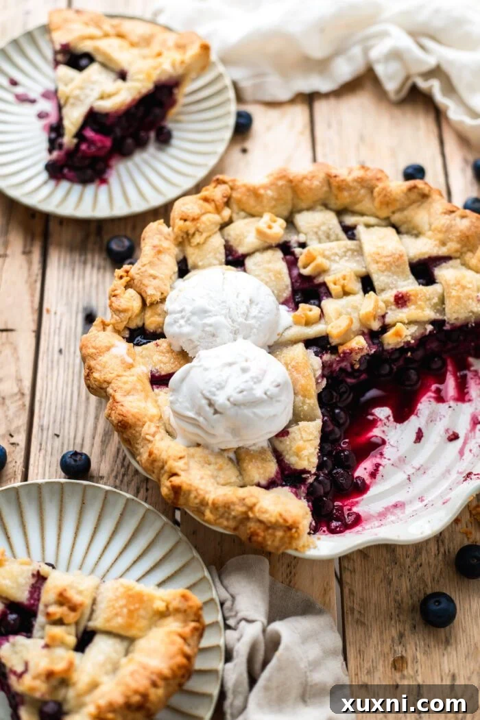 sliced vegan blueberry pie with scoops of blueberry pie