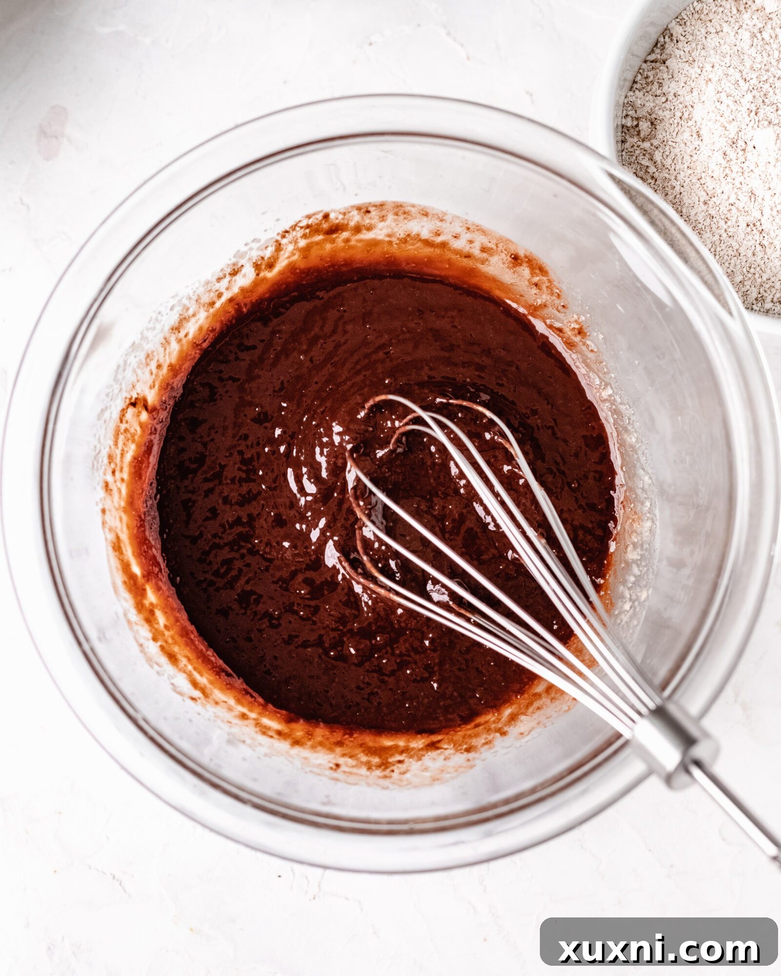 Fully melted chocolate chips smoothly blended into vegan butter, creating a glossy chocolate base.