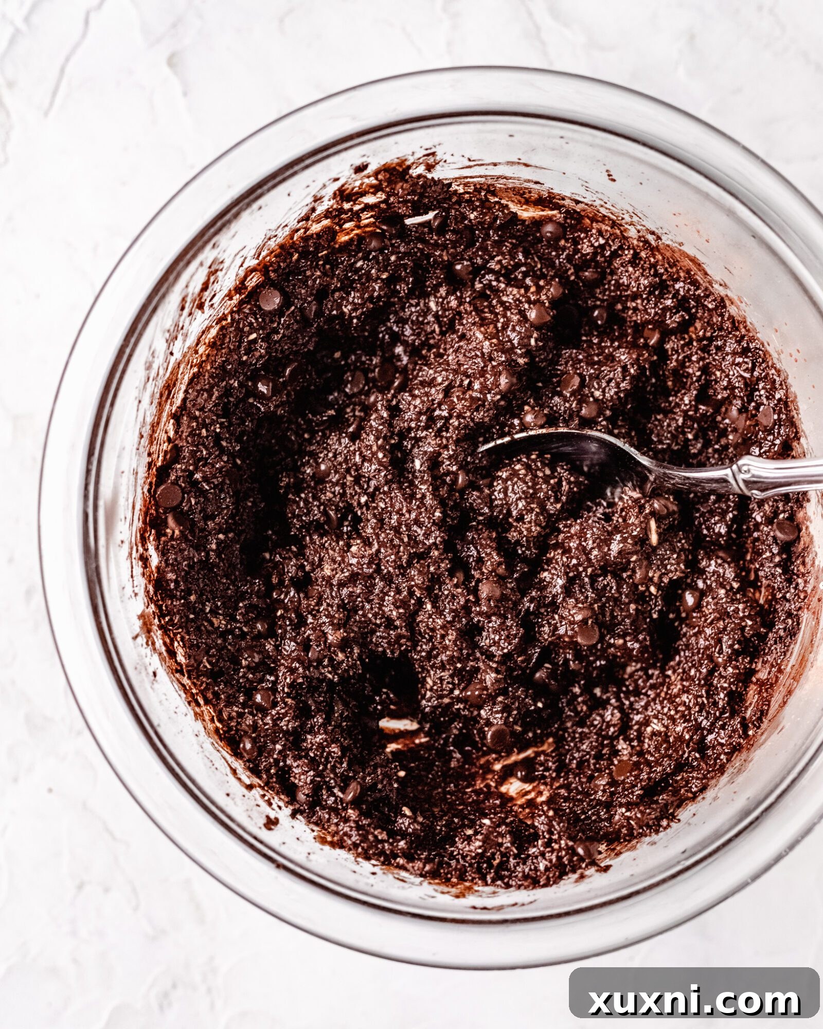 The finished, thick, and fudgy edible brownie batter after all ingredients have been thoroughly combined.