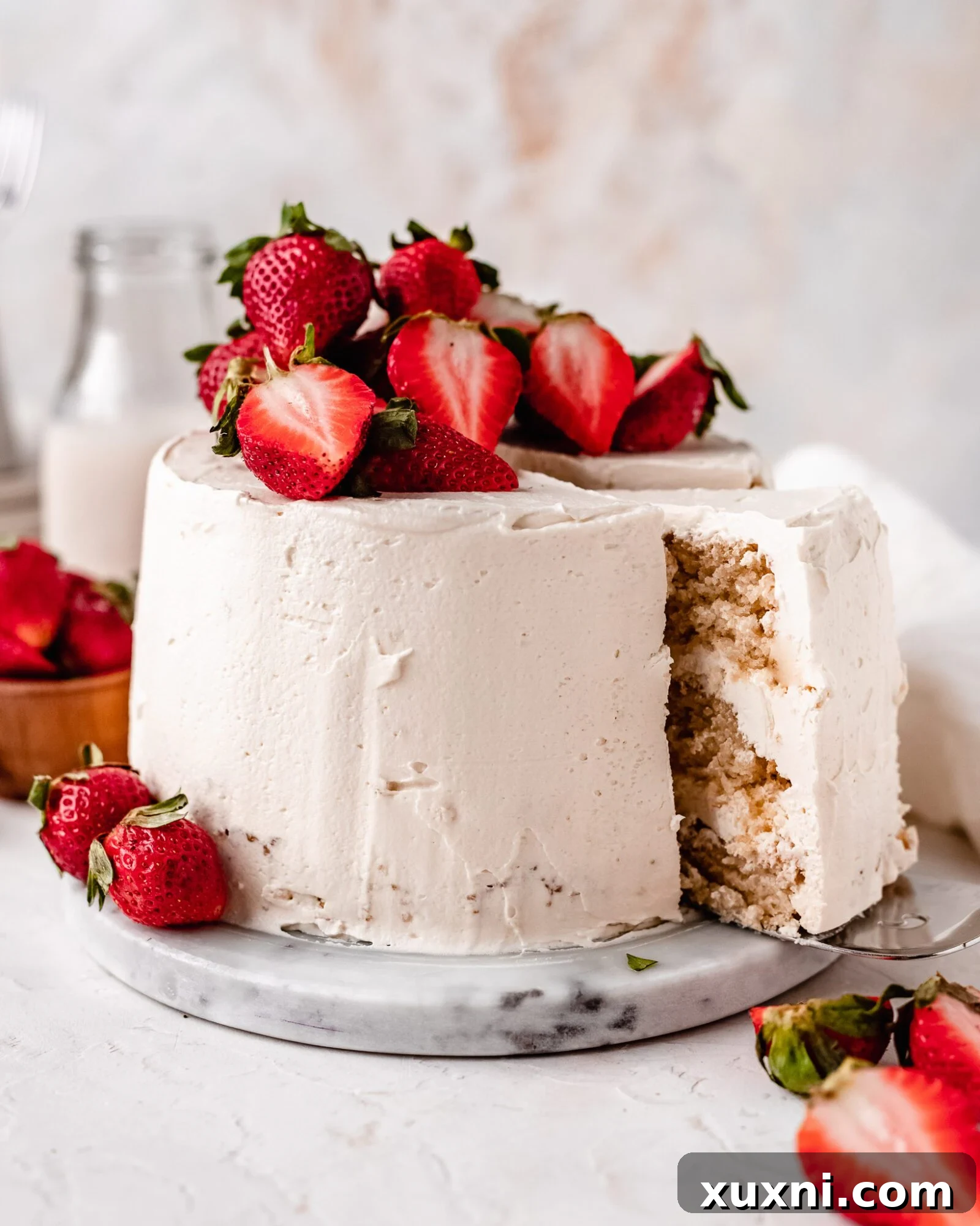 A beautifully decorated Strawberry Vanilla Chiffon Cake, eggless and dairy-free, topped with fresh strawberries.