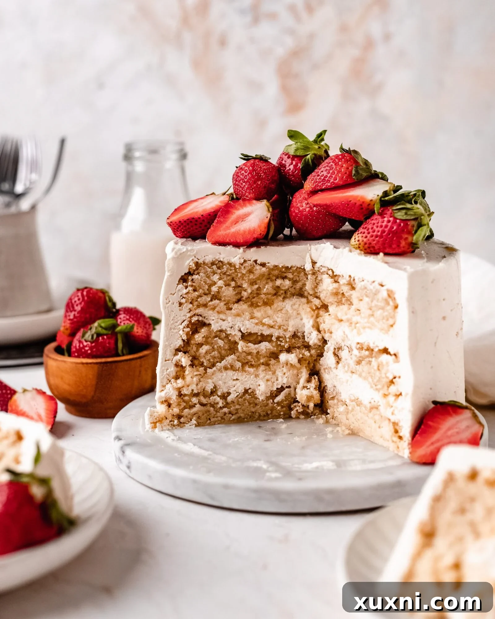A perfectly sliced vegan sponge cake revealing its delicate, airy, and moist texture, showcasing the layers.