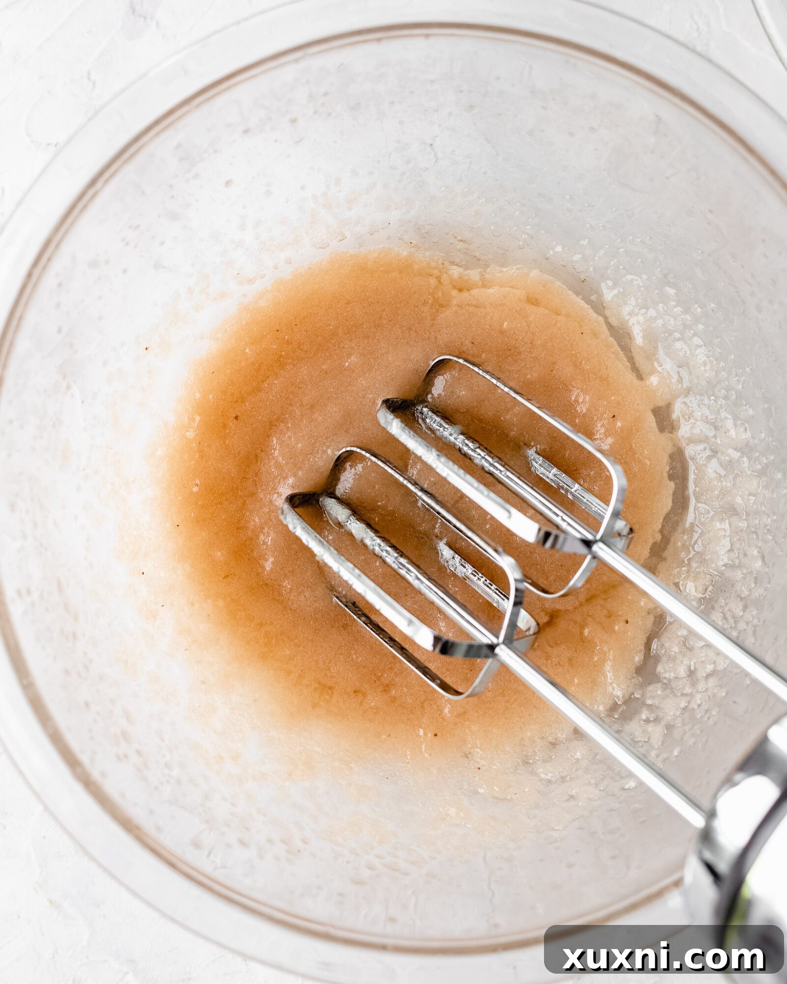 Wet ingredients for vegan chiffon cake thoroughly mixed in a bowl, showing a smooth and uniform liquid.