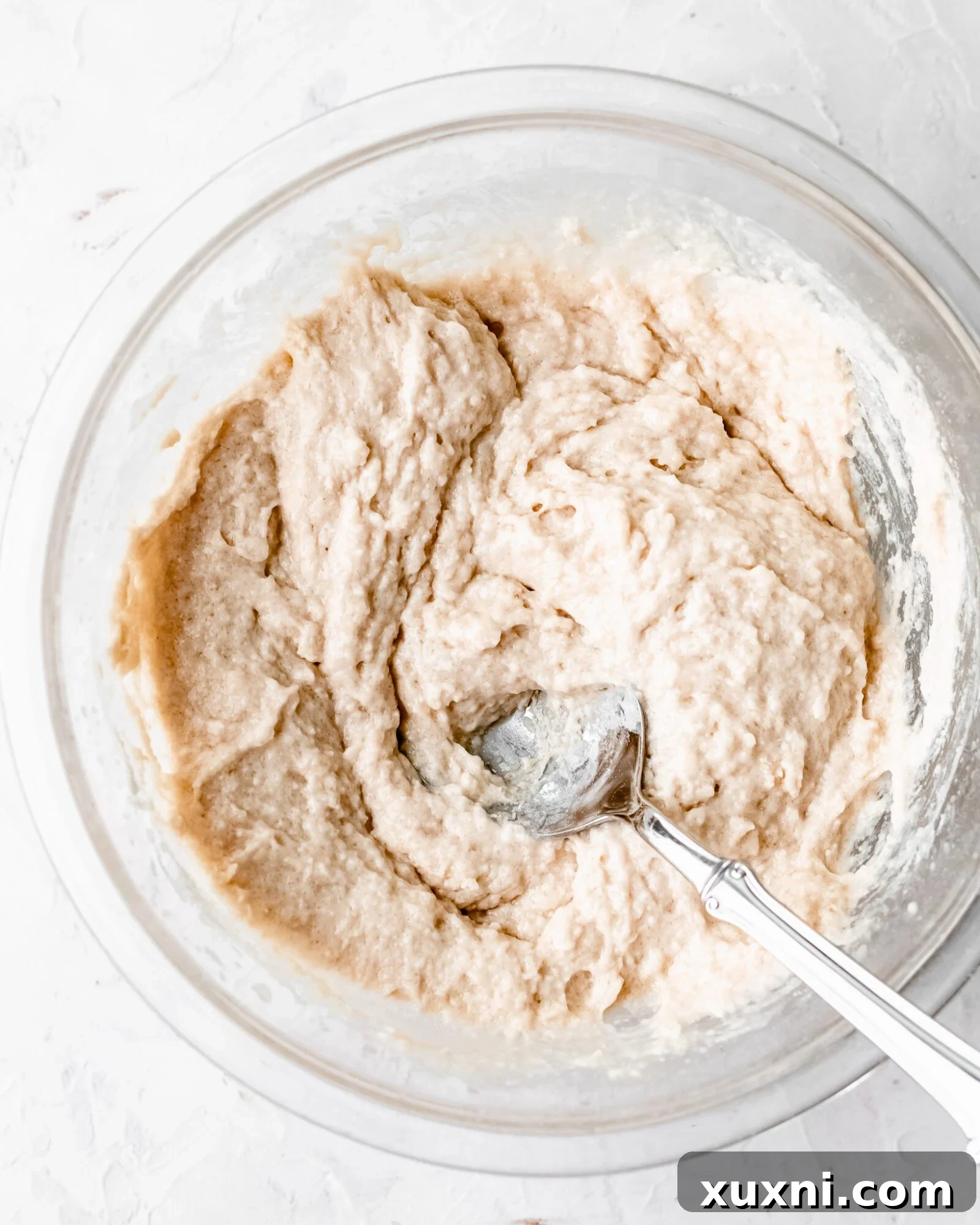 Thick, smooth cake batter for vegan chiffon cake in a mixing bowl, ready to be combined with meringue.