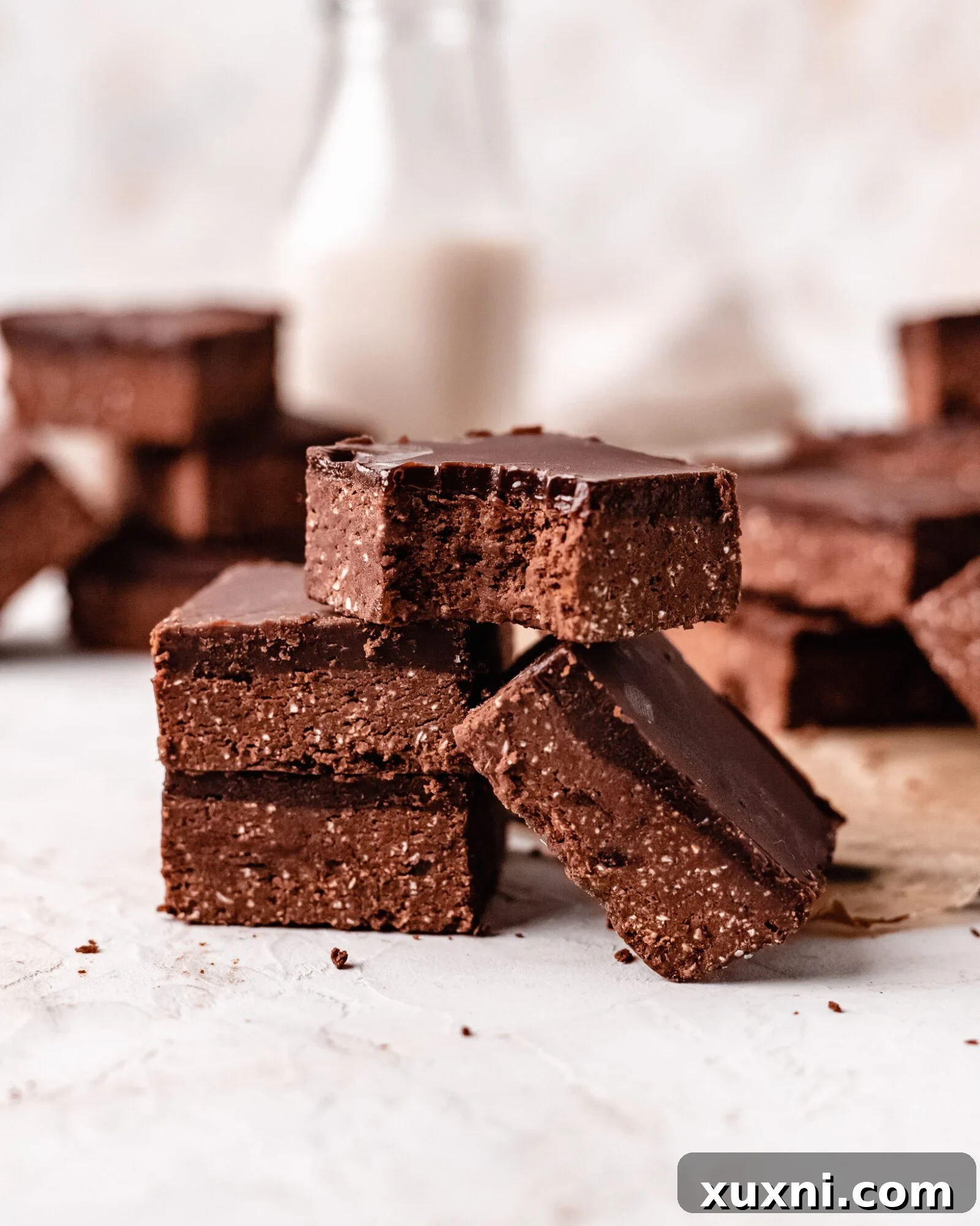 Super fudgy healthy no-bake brownies, perfectly sliced and ready to eat, showcasing their rich texture.