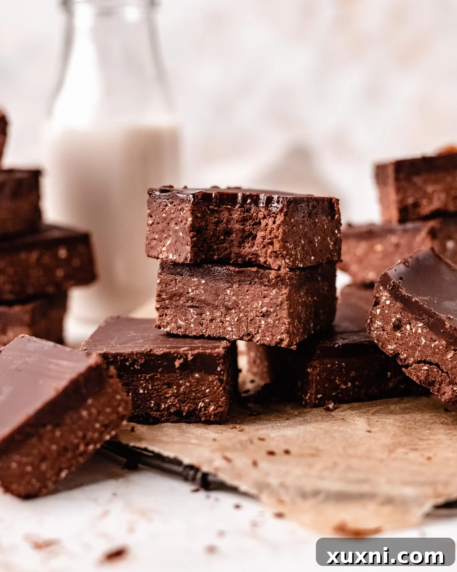 A stack of perfectly prepared no-bake brownies, showcasing their irresistible fudgy layers and delicious appeal.