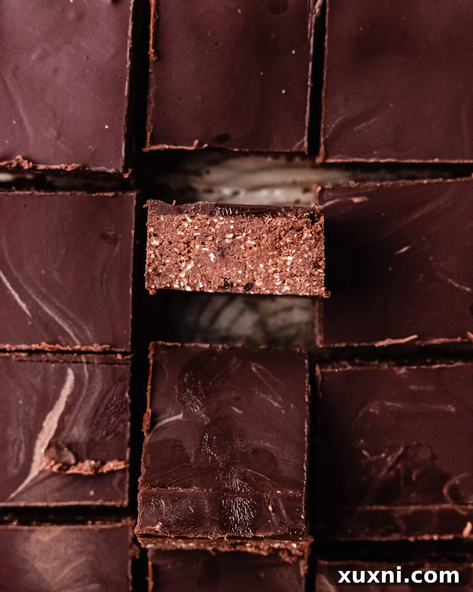 Neatly sliced healthy vegan gluten-free brownies topped with chocolate ganache, ready to be enjoyed.