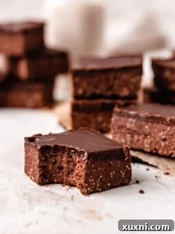 A delicious healthy no-bake vegan brownie with a bite taken out, perfect for the recipe card.