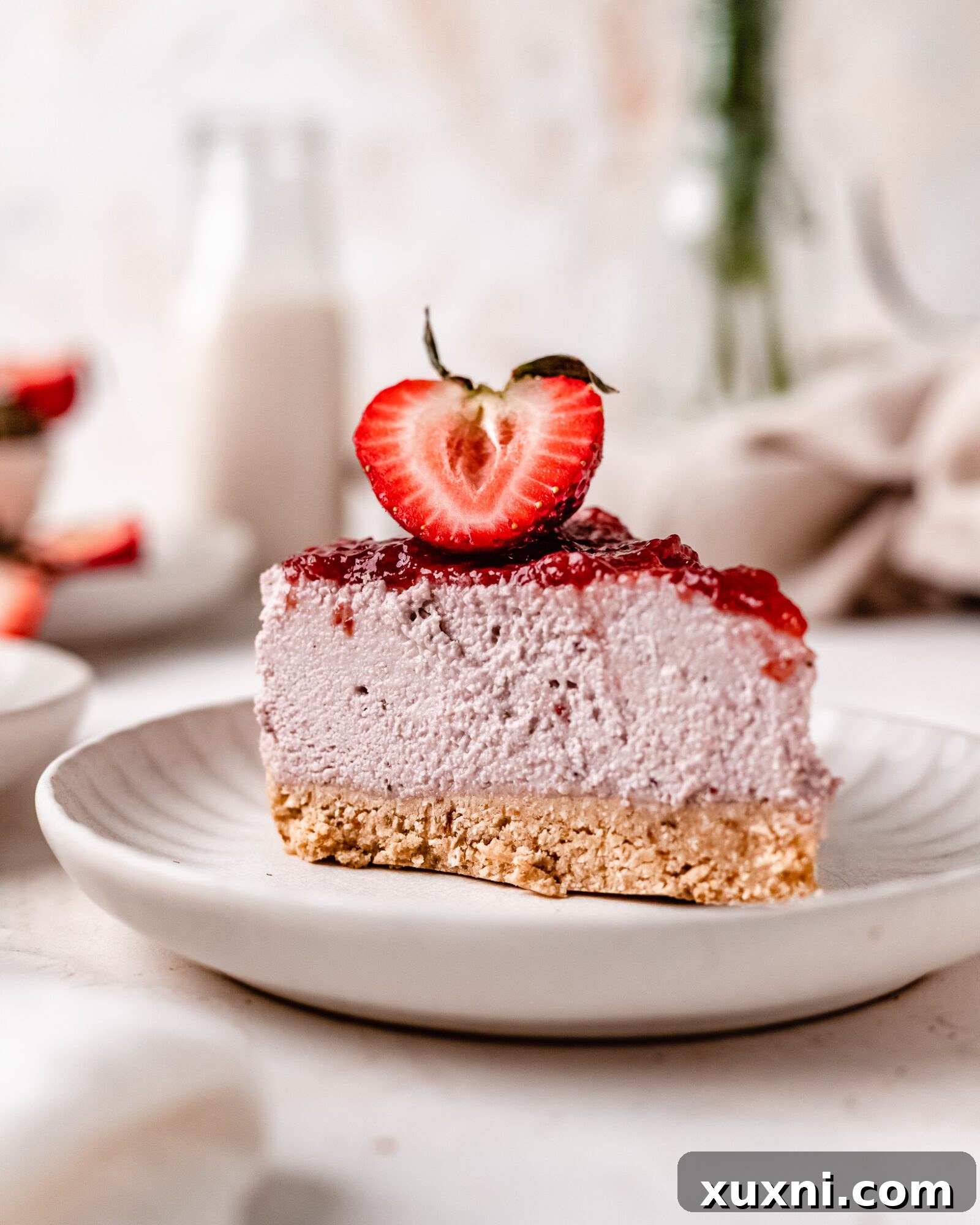 Close-up of a perfectly sliced vegan strawberry cheesecake