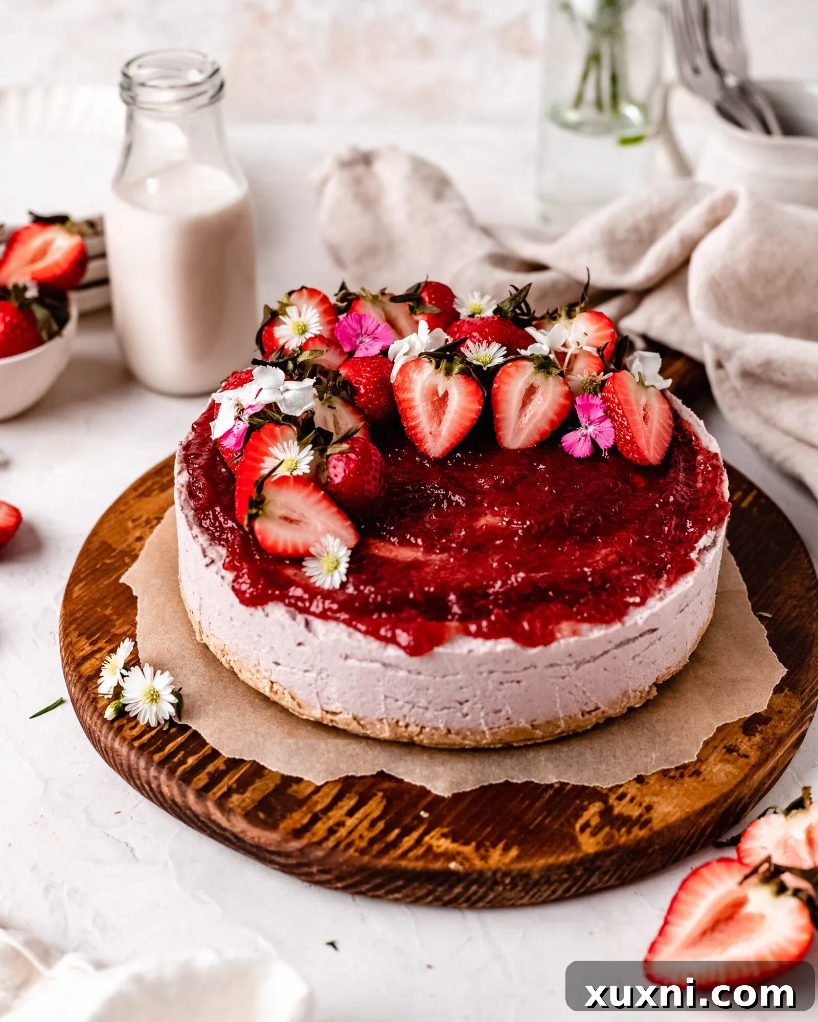 Whole no-bake vegan strawberry cheesecake setting in a springform pan