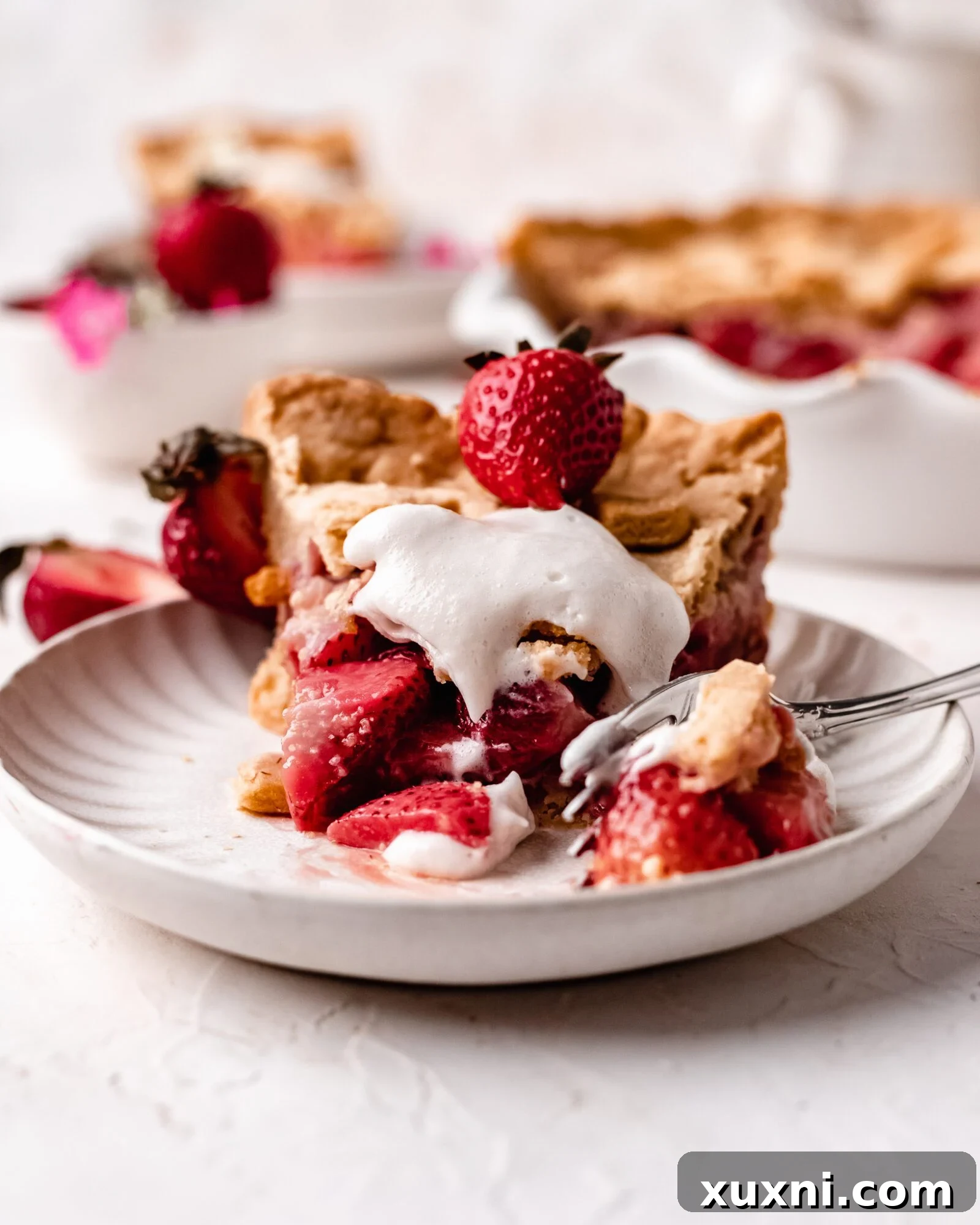 A vibrant slice of homemade vegan strawberry pie with a flaky crust, perfect for summer.