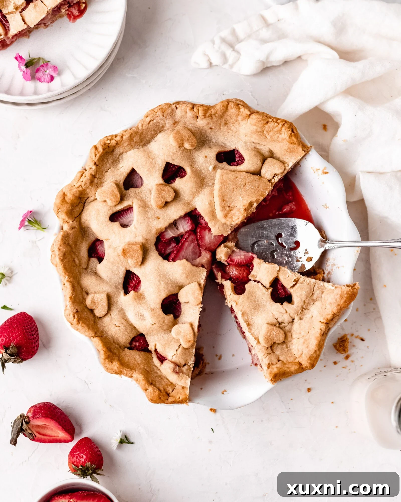 Close-up of a freshly baked vegan strawberry pie, showing its golden crust and juicy filling.