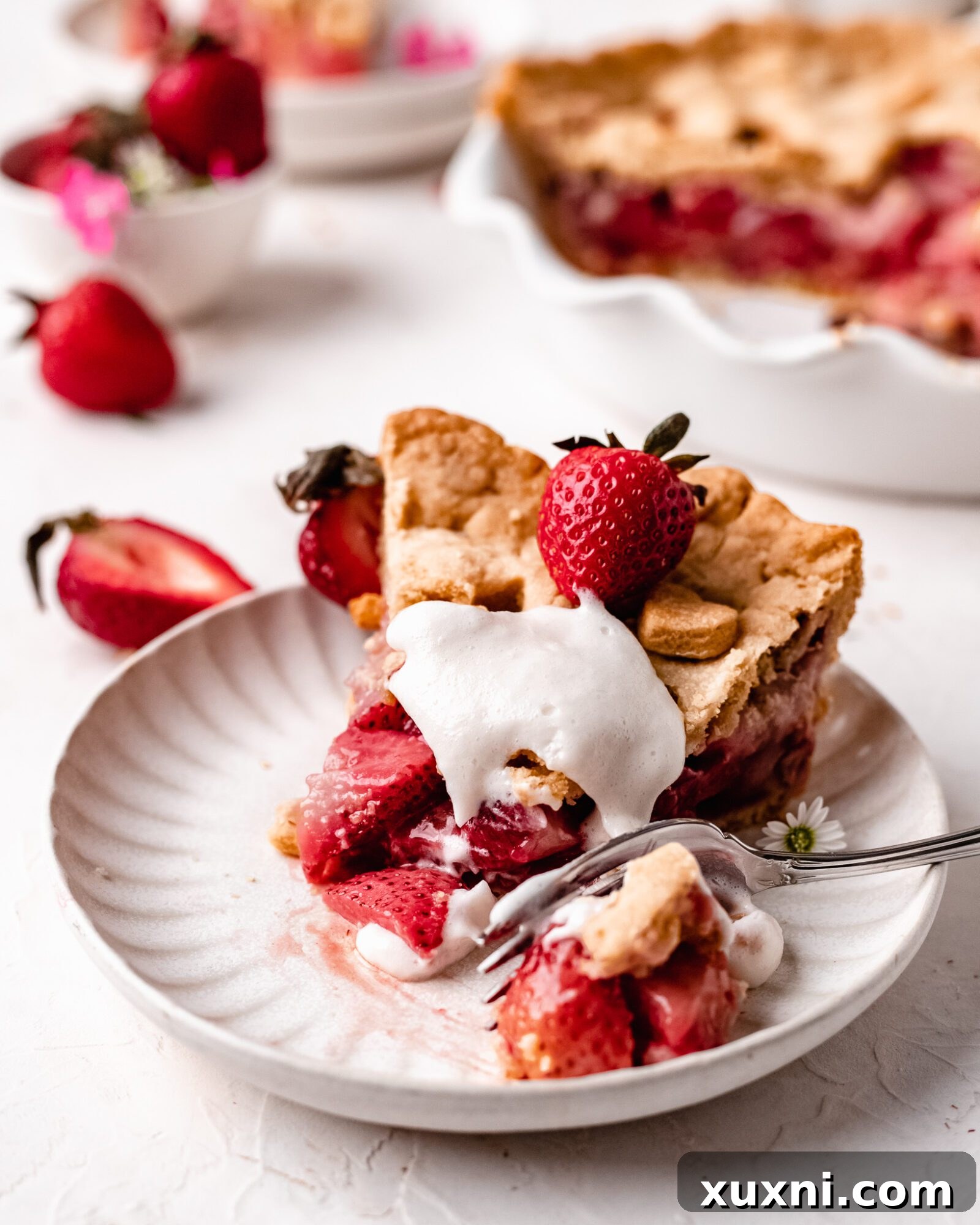 A perfectly baked slice of vegan strawberry pie on a plate, showcasing its texture.