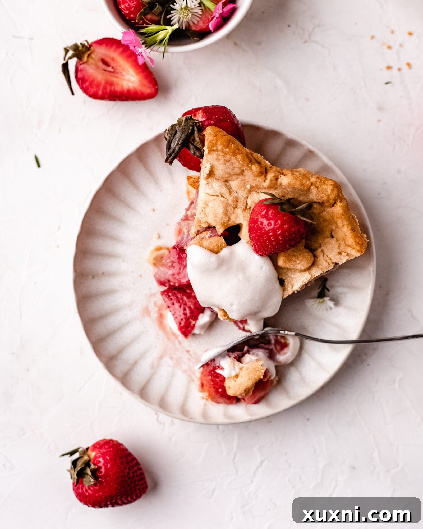 A close-up shot of a fresh strawberry pie, ready for serving.