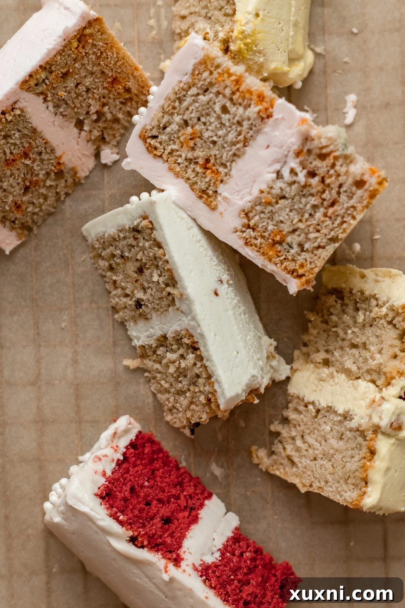 Close-up of several slices of vegan mini cakes, revealing moist crumb and layered frosting.