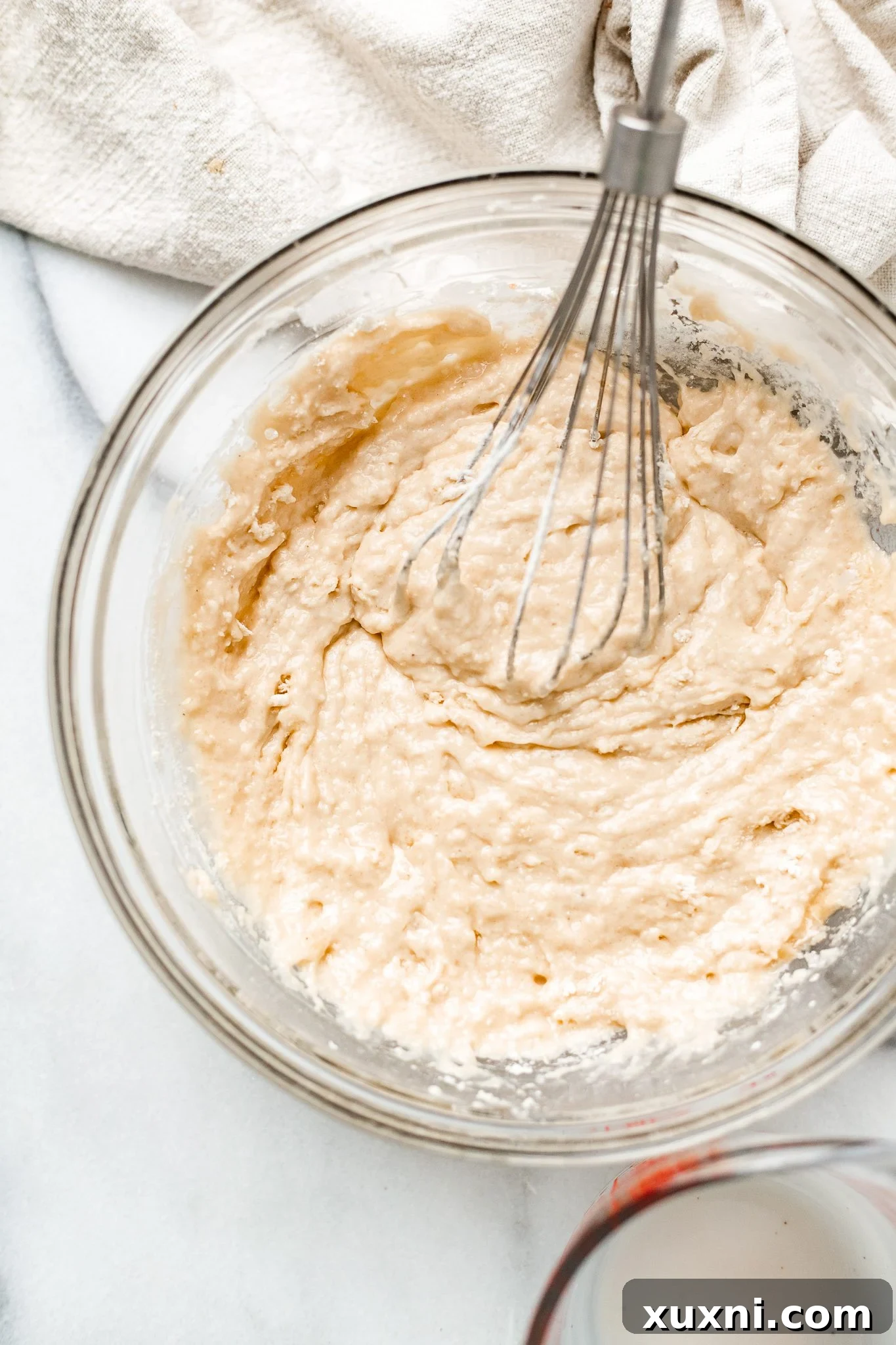 Smooth, colorful cake batter in a mixing bowl, ready for baking.