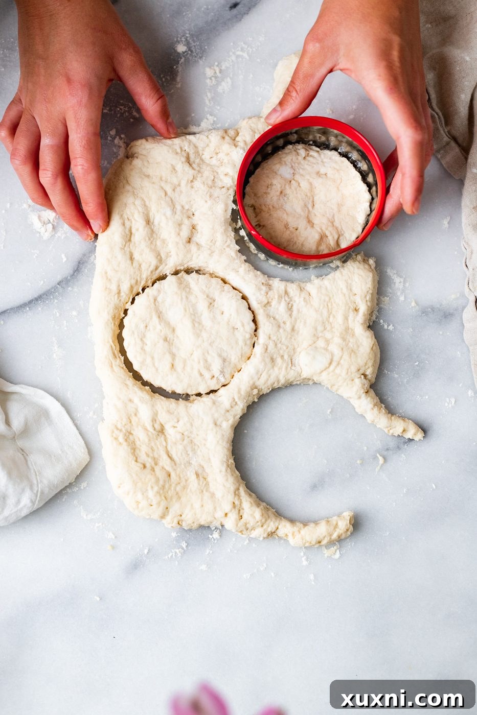 using a biscuit cutter to shape dough