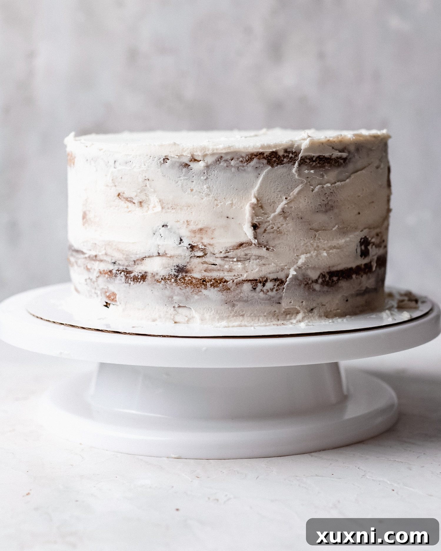 Applying a crumb coat to ice cream cake