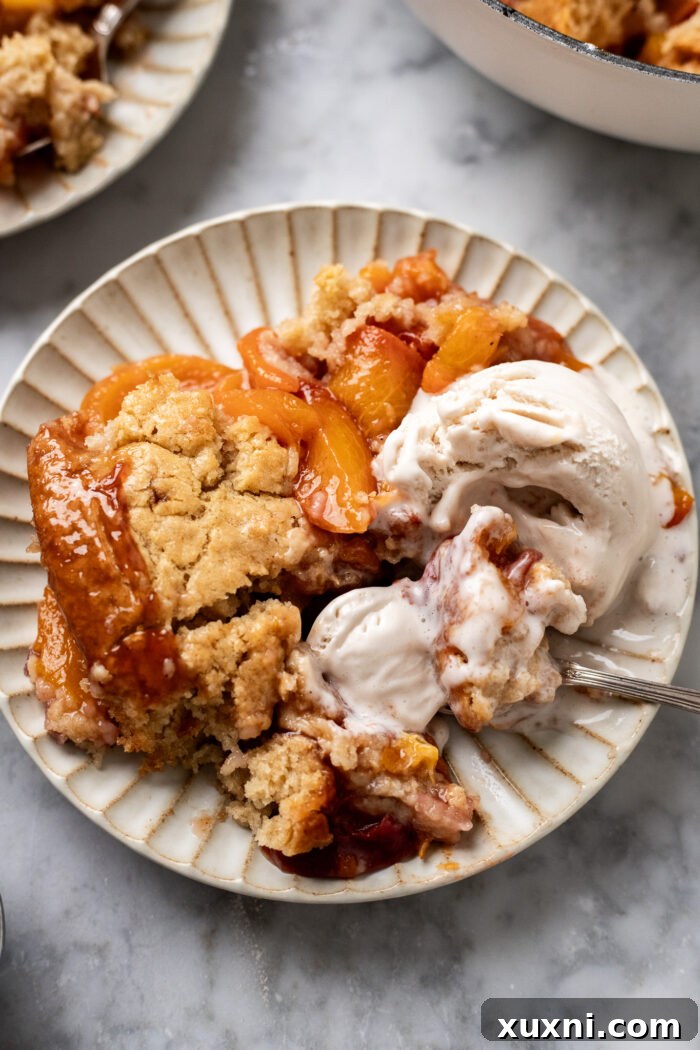 plate of vegan peach cobbler on a plate