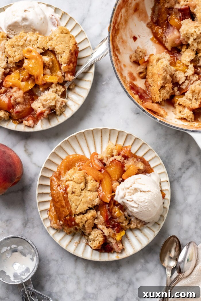plates of vegan peach cobbler on marble table