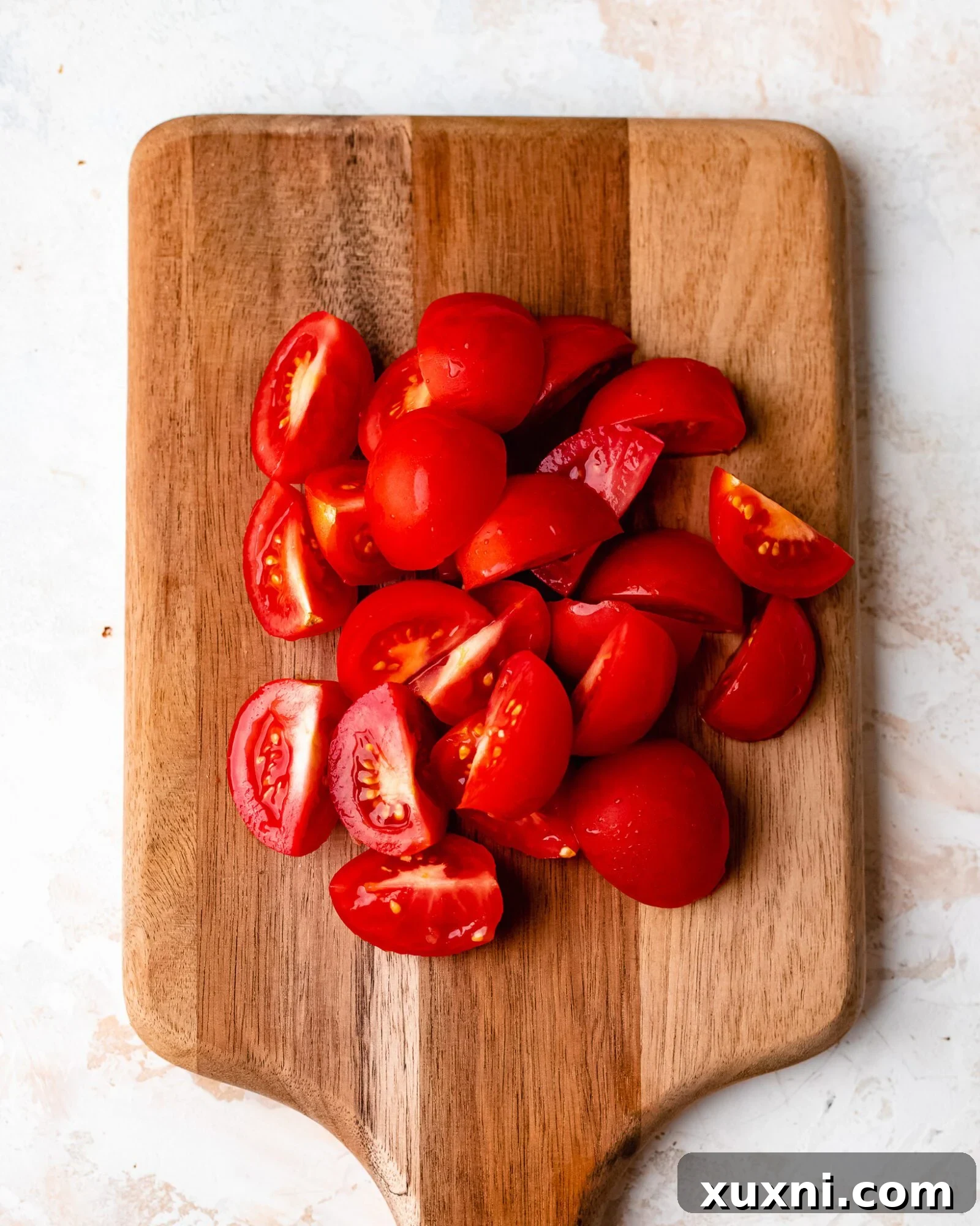chopped tomatoes - Freshly chopped Compari tomatoes, vibrant red and ready for the pasta salad.