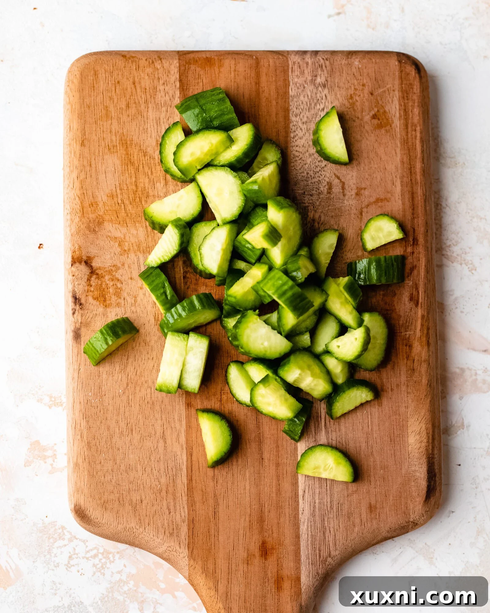 chopped cucumber - Freshly chopped Persian cucumbers, green and crisp, prepared for the salad.