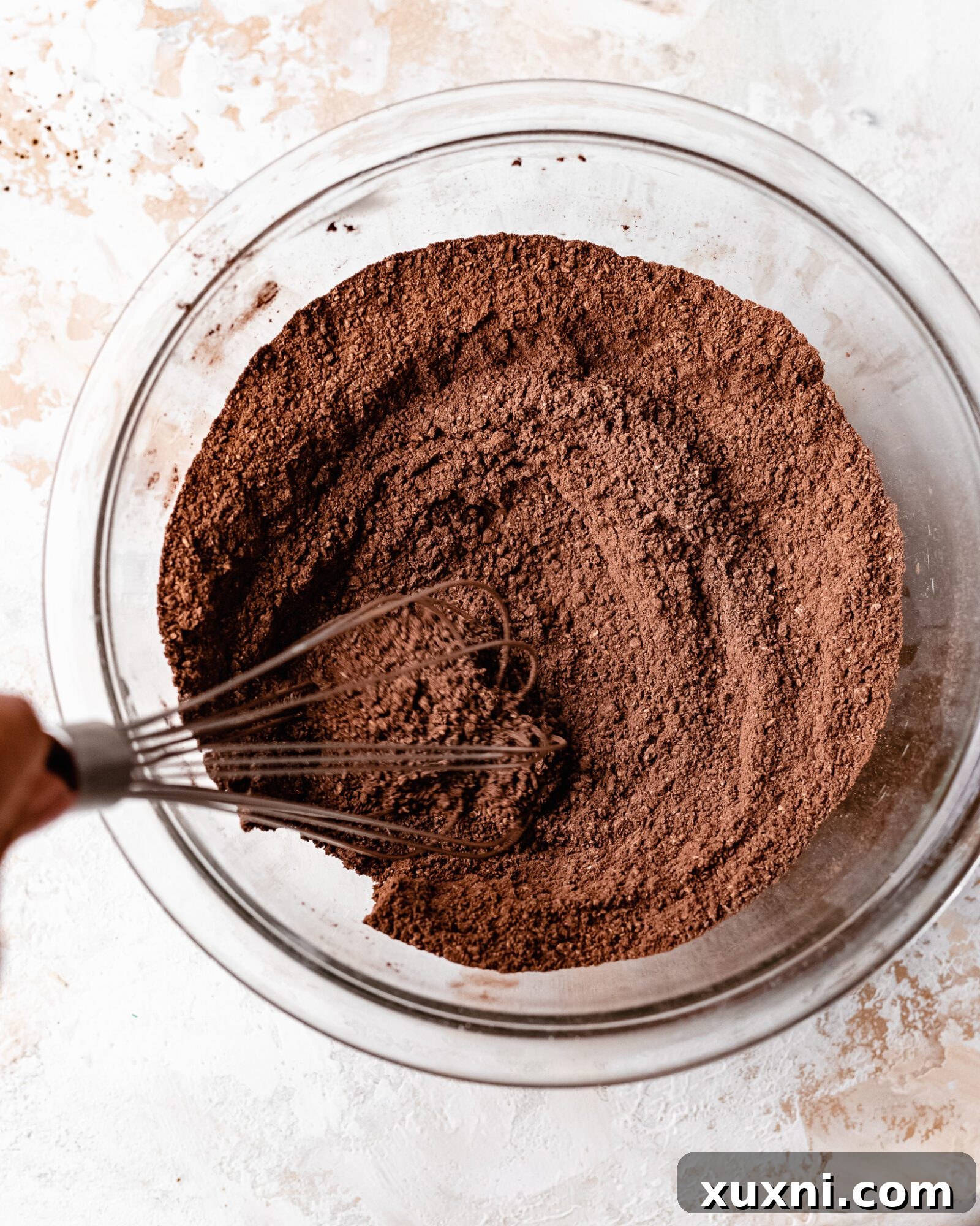 Dry ingredients being whisked together in a bowl for the skillet brownie.