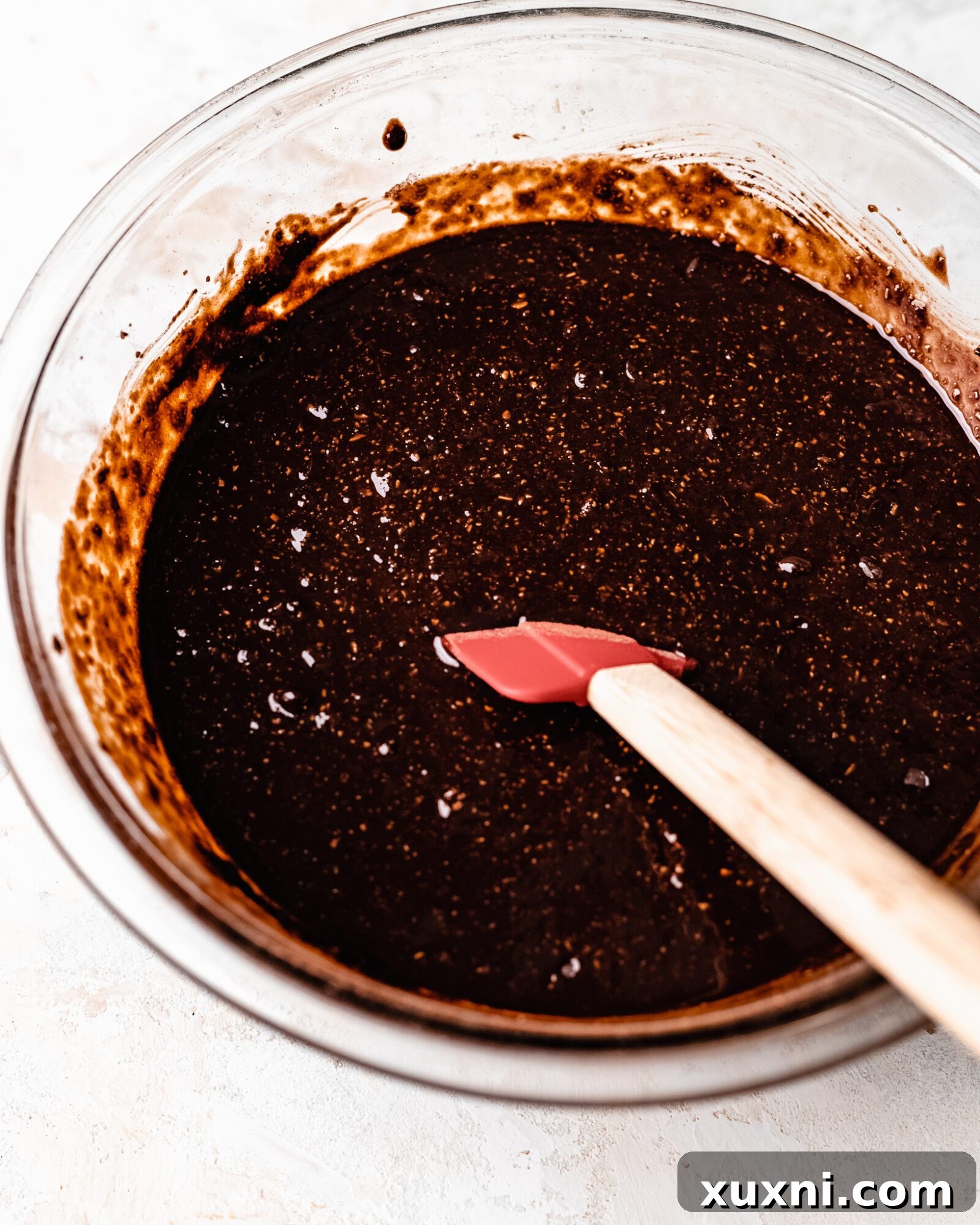 Chocolate chips being added to the brownie batter.