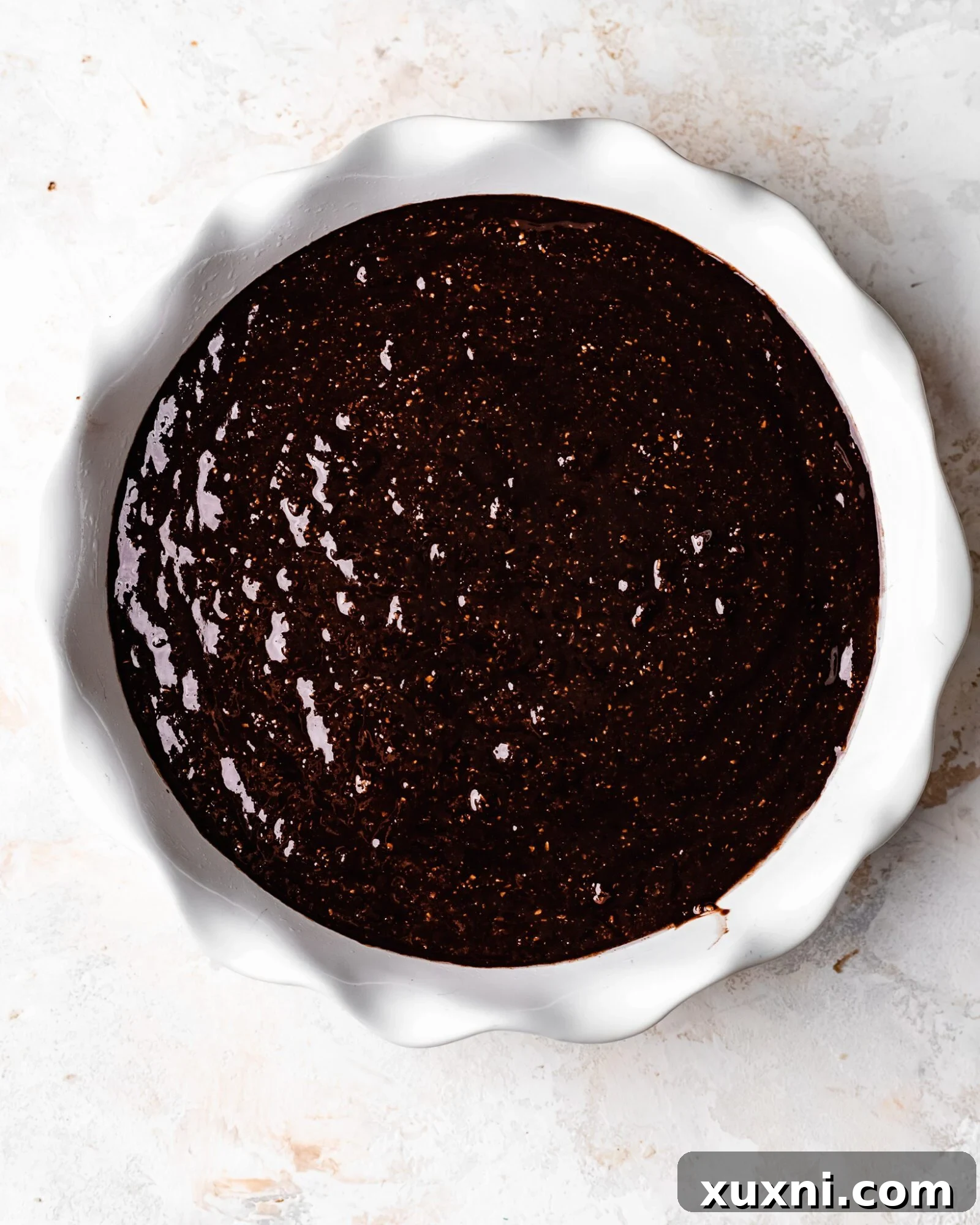Unbaked skillet brownie batter in a skillet, ready to go into the oven.