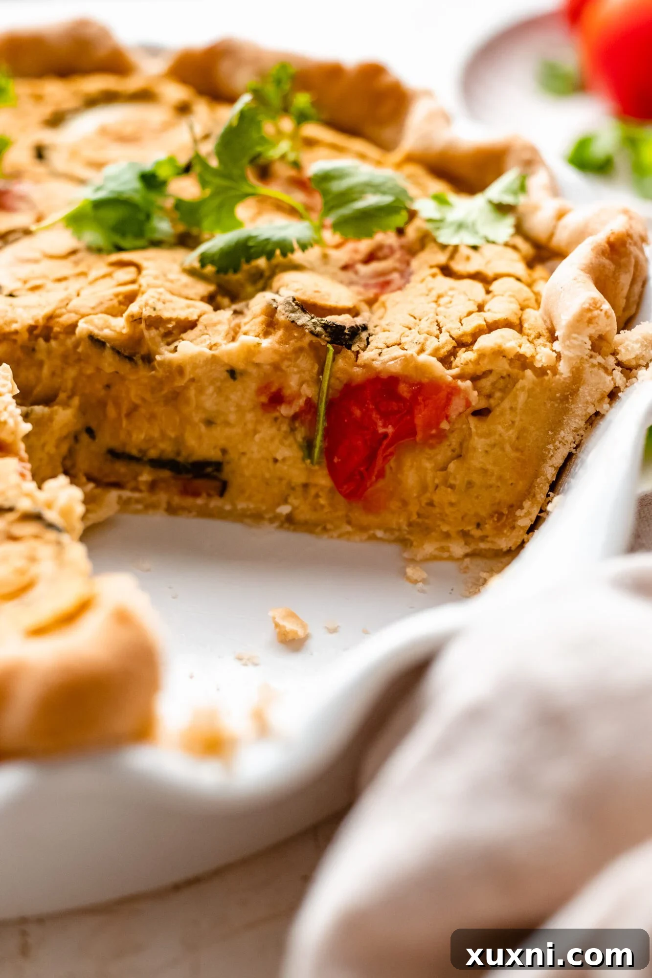 sliced vegan quiche served on a rustic board