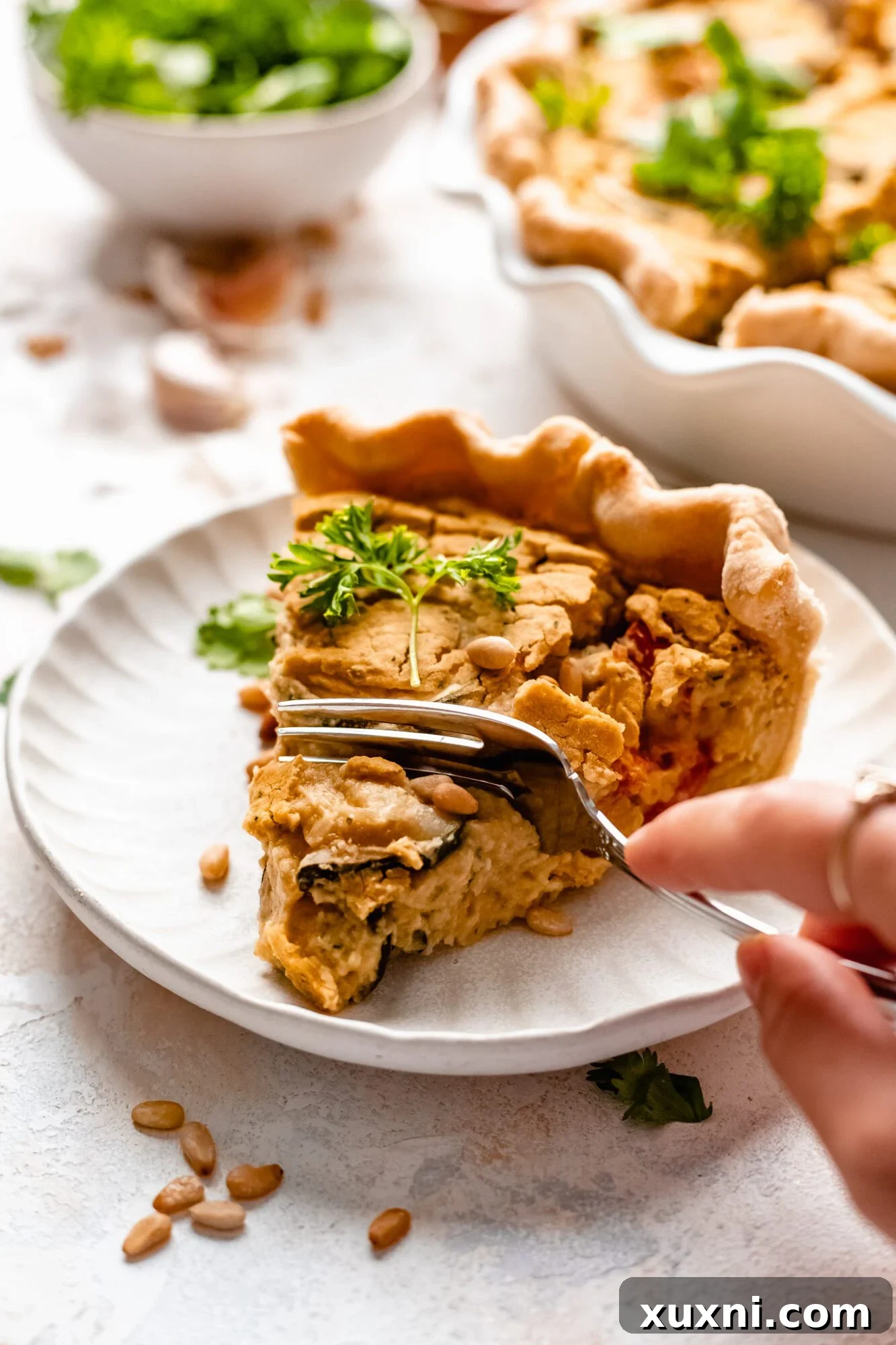 slice of vegan quiche on a plate with fork