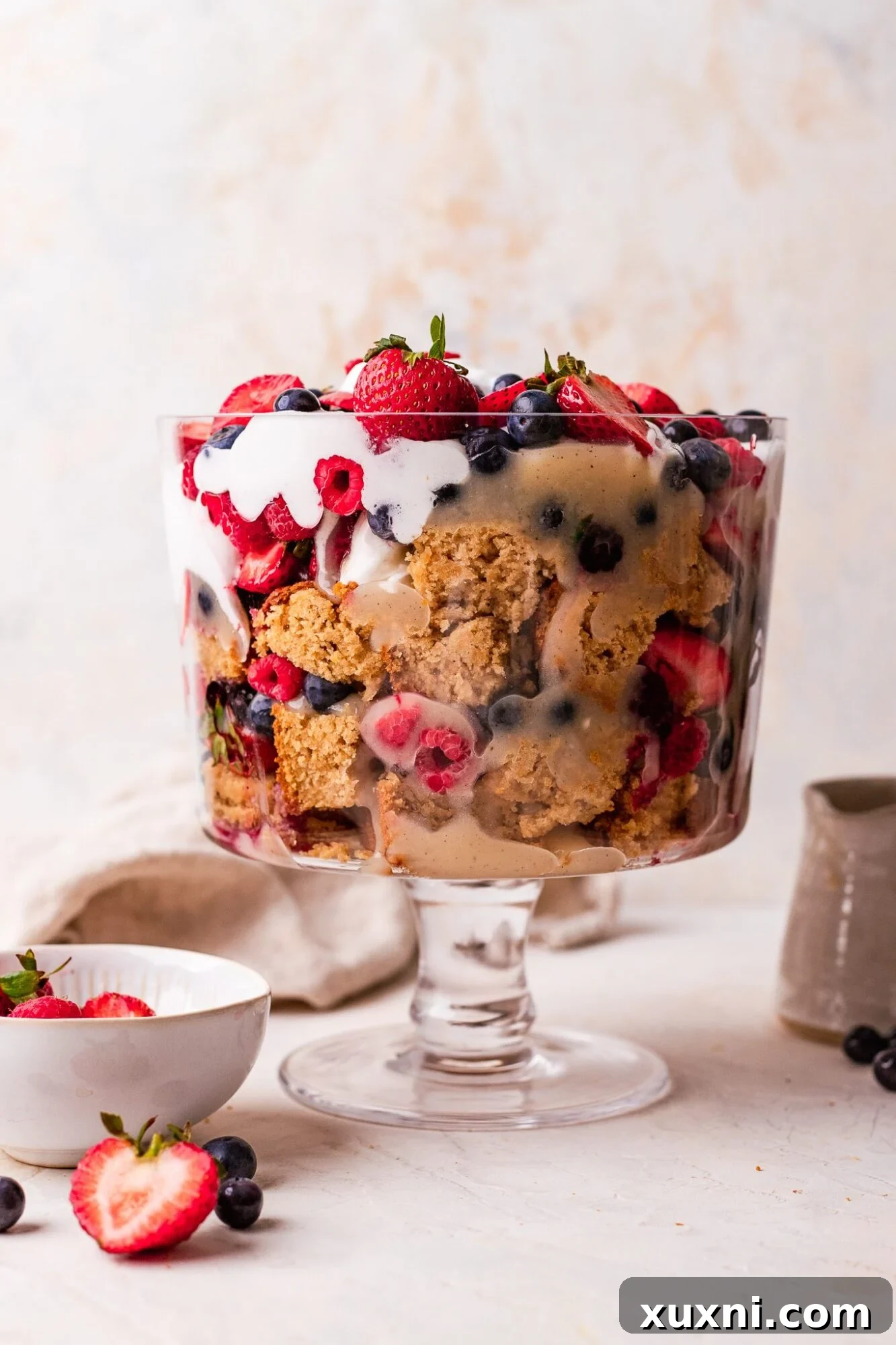 Vibrant and easy lemon berry vegan trifle with layers of custard, cake, berries, and whipped cream, perfect for summer parties.