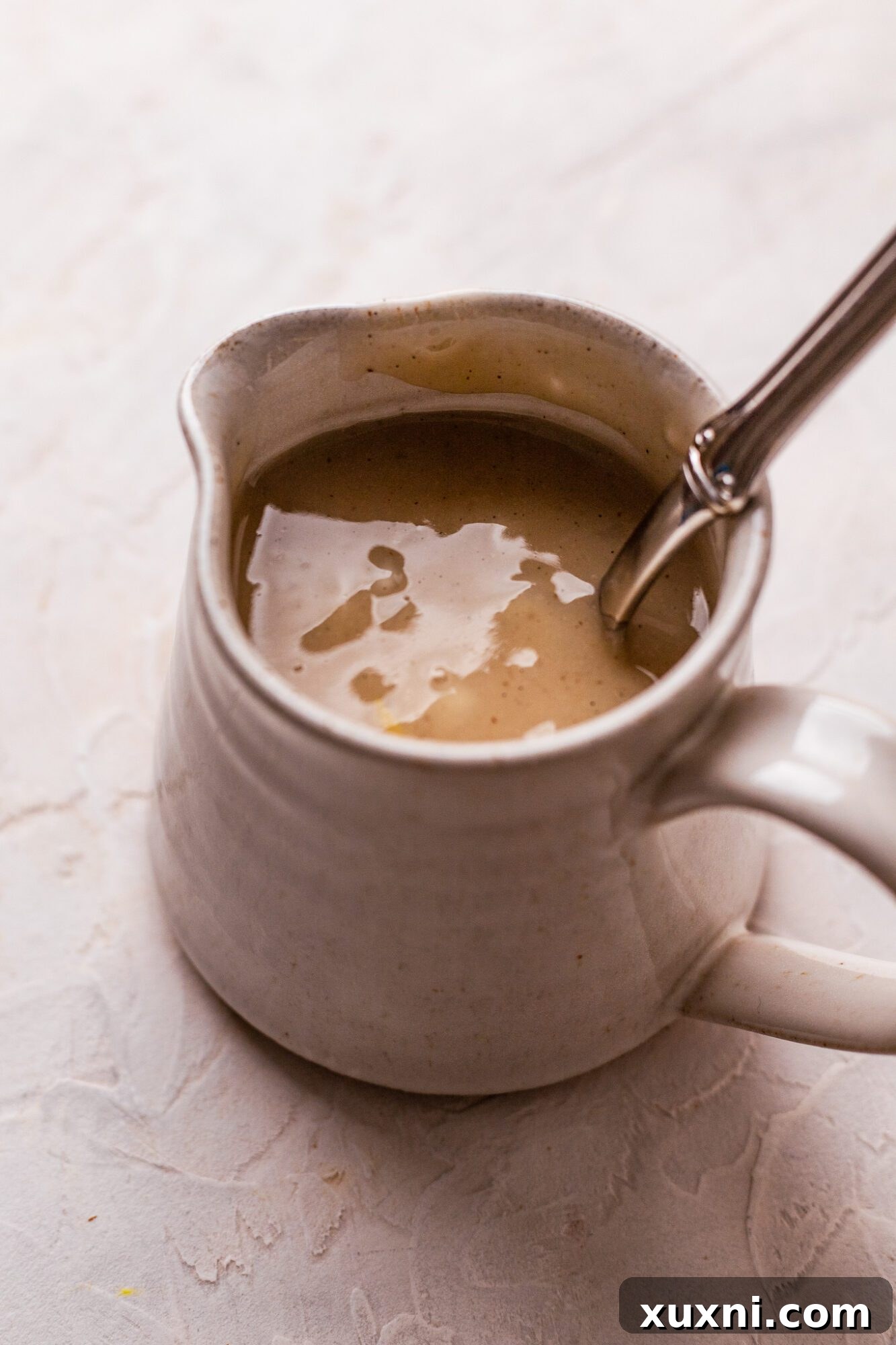 Smooth and creamy vegan lemon custard, vibrant yellow and ready for layering.