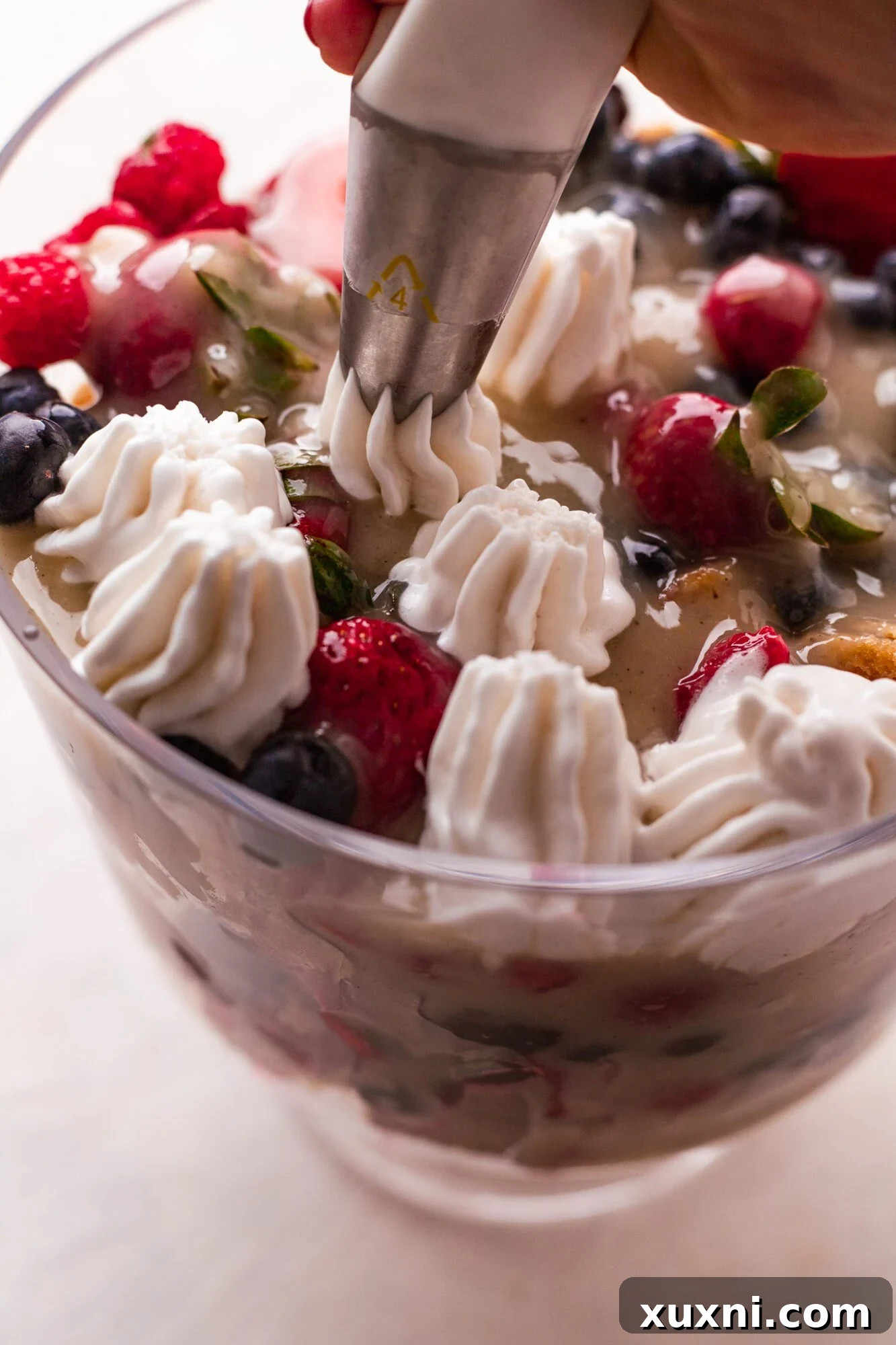 Fluffy homemade coconut whipped cream, piled high and ready to top a dessert.