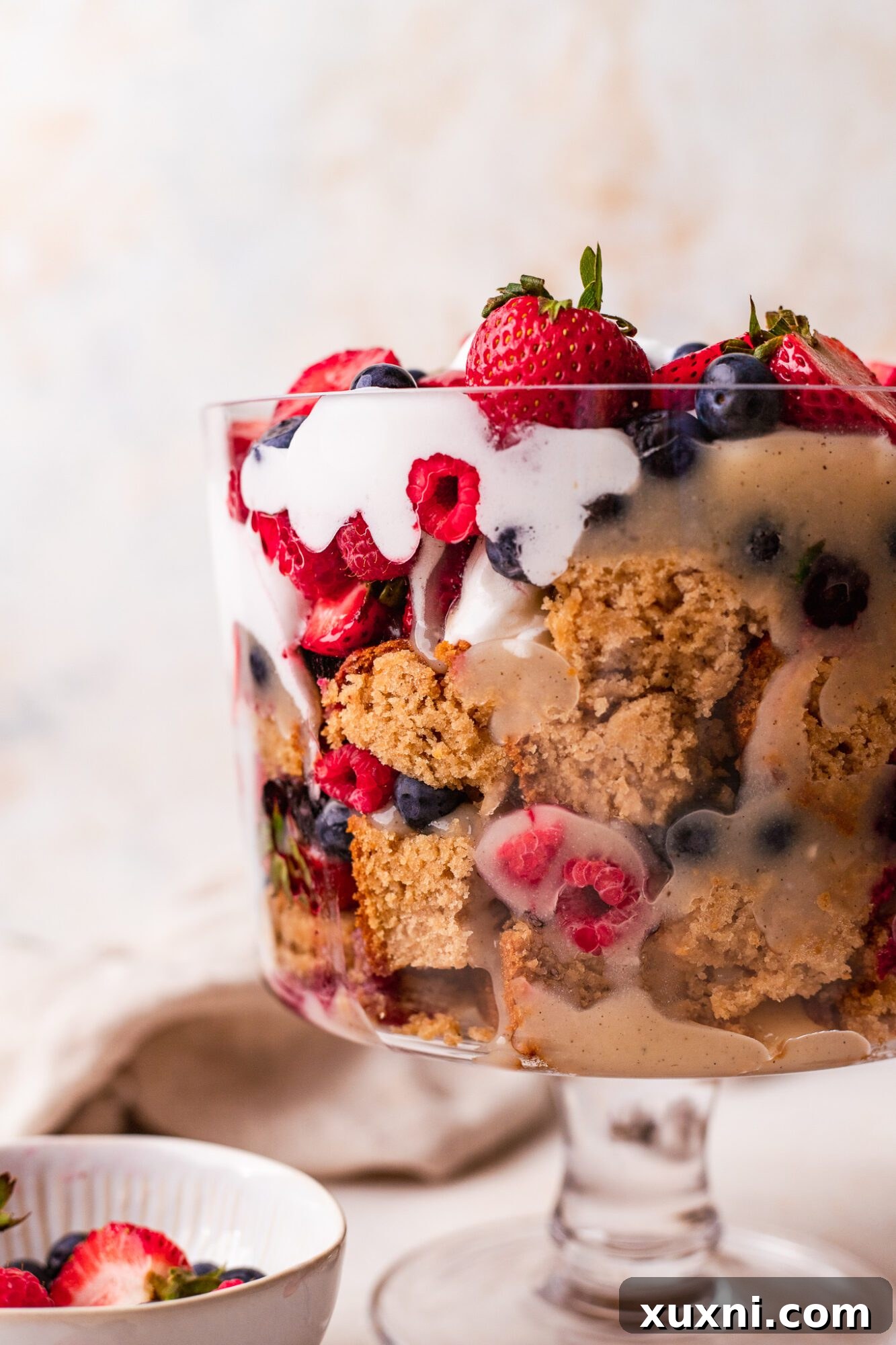 The impressive layered structure of the lemon berry vegan trifle, showcased in a clear glass dish.